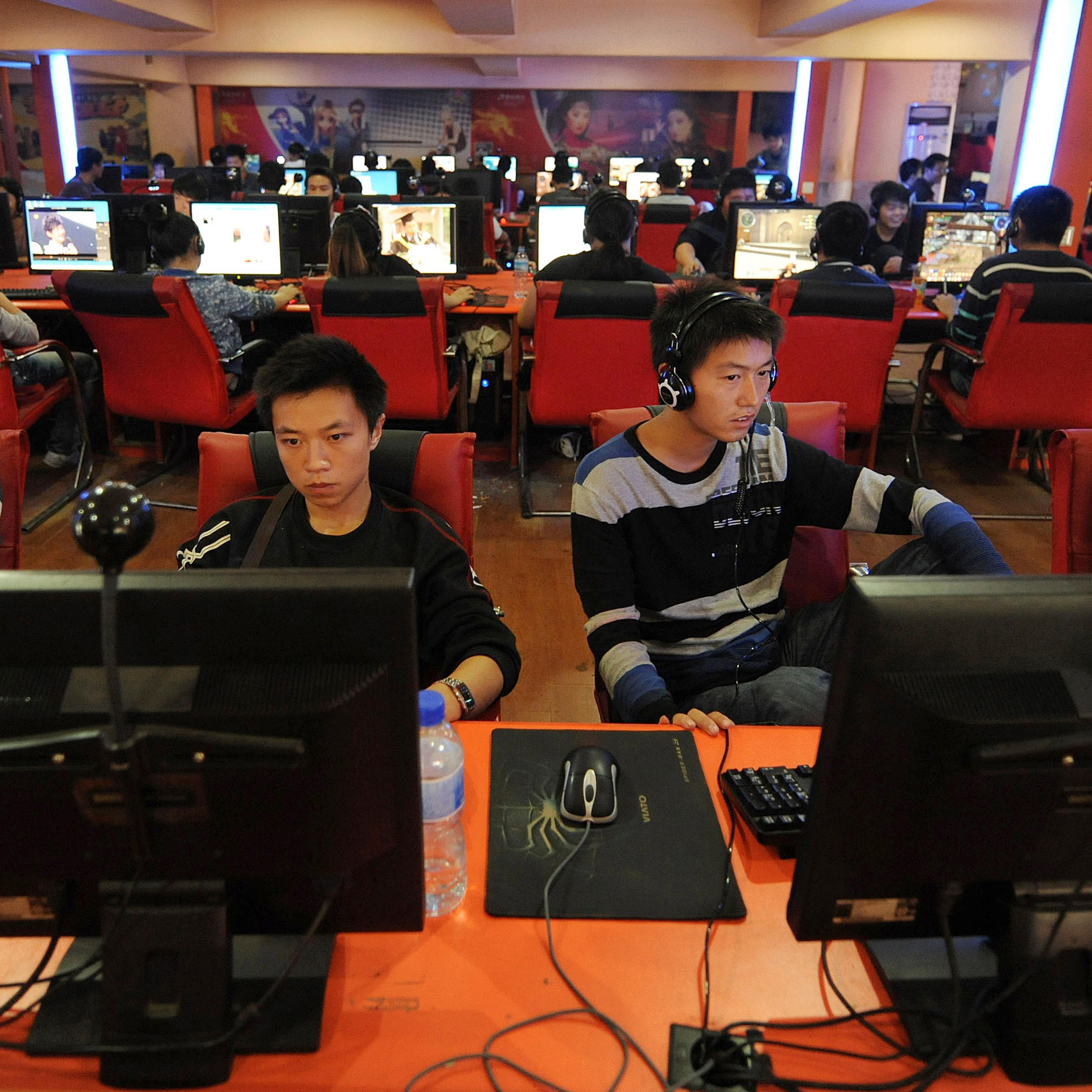 People use computers at an Internet cafe in Hefei