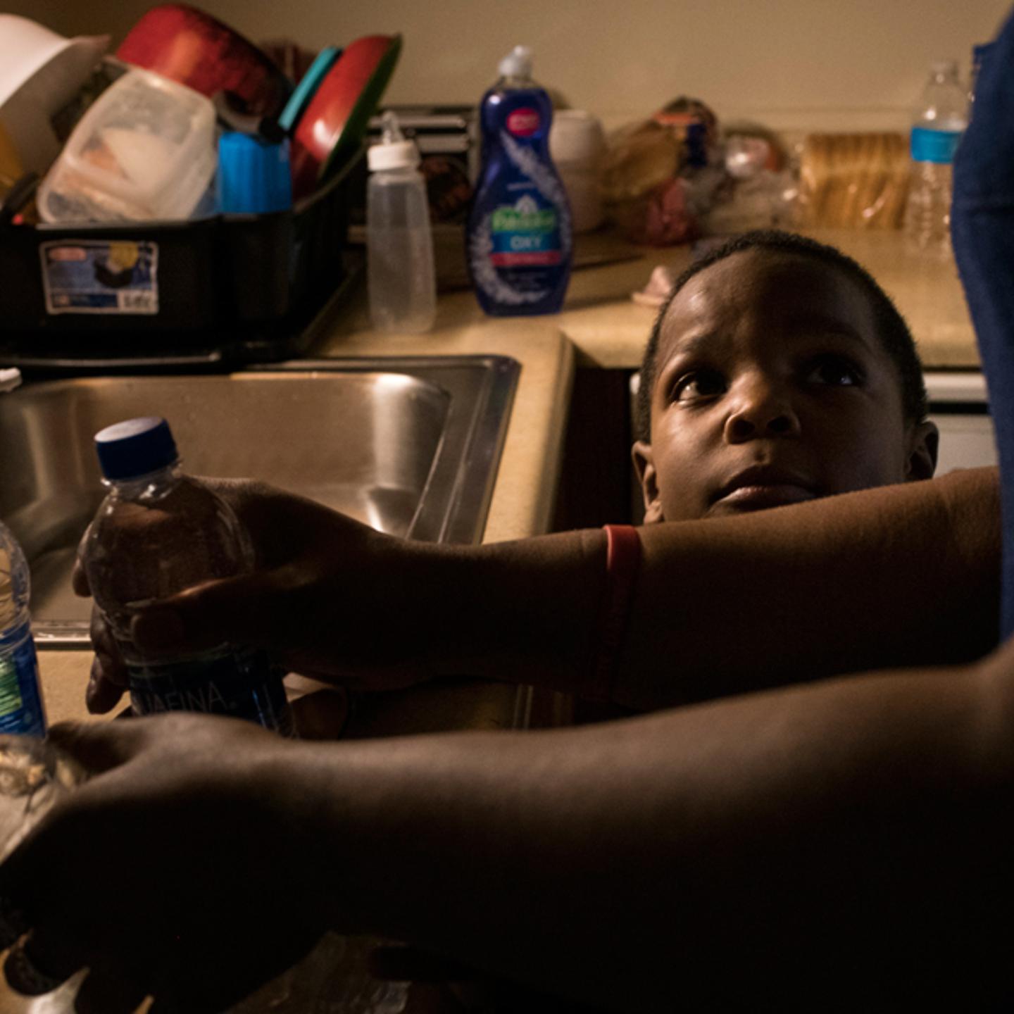 Ariana Hawk, mother of Sincere, now 6, starts warming bottled water to prepare a bath for her two younger children in April 2018.