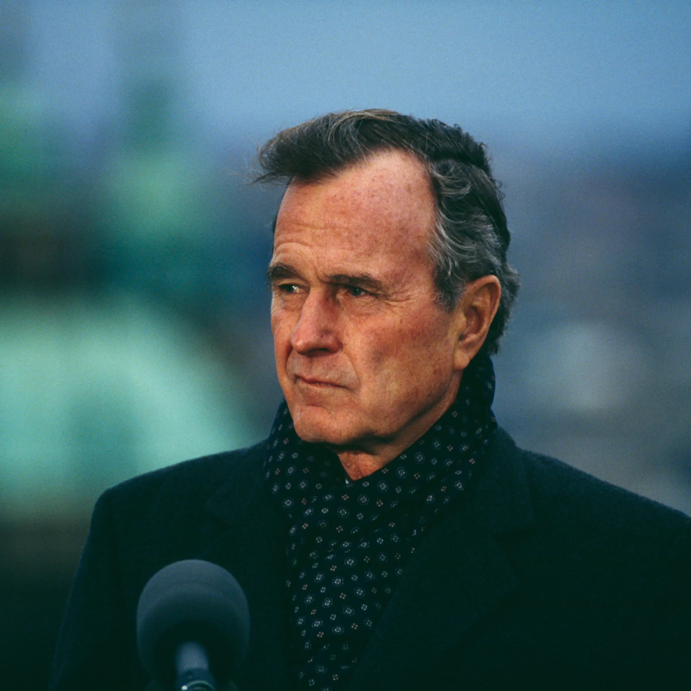 President George H.W. Bush bundled-up against autumn chill, speaking while visiting Prague, Czechoslovakia, November 18, 1990.