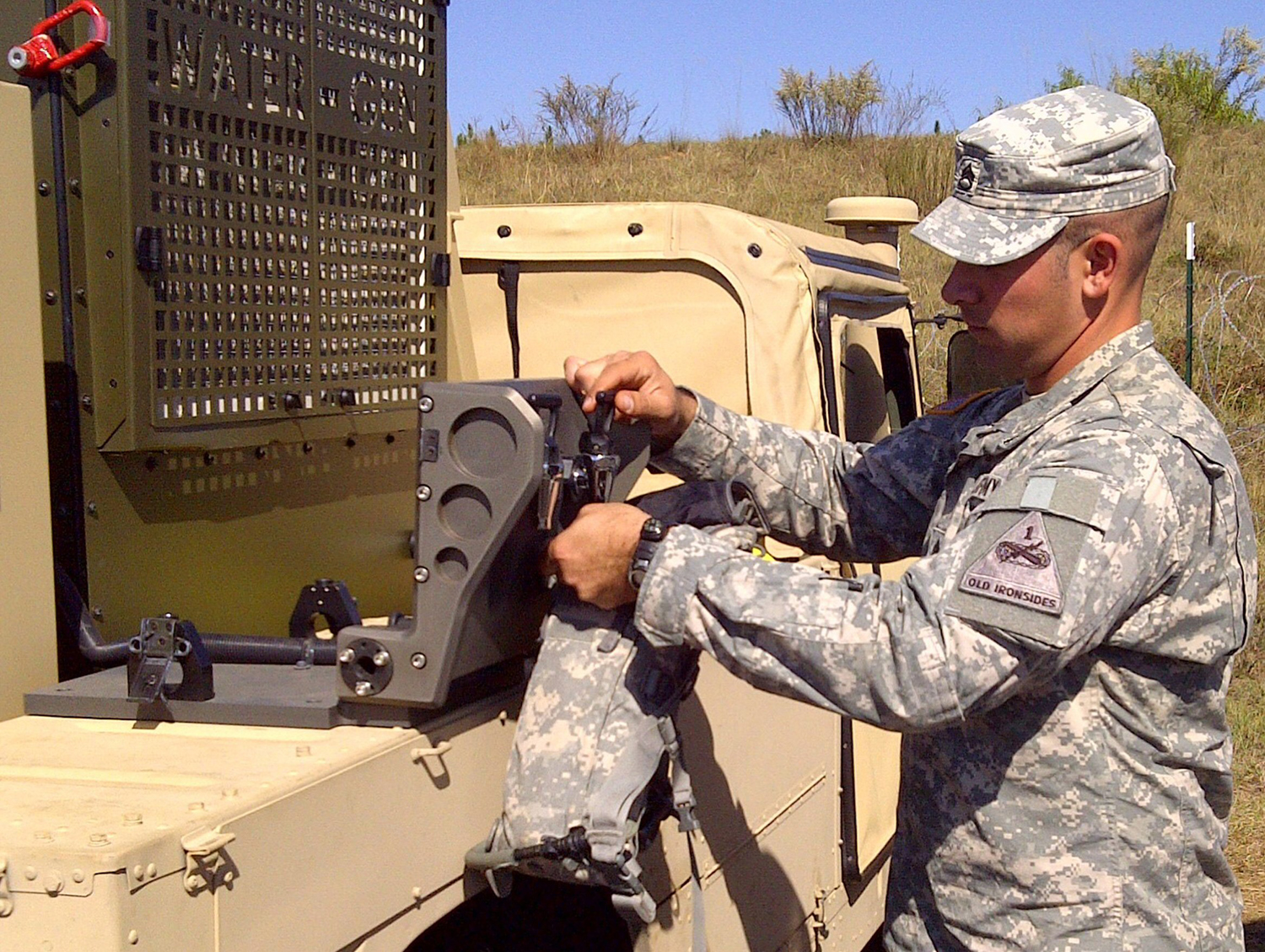A U.S. Army member pours water generated by Water-Gen's Atmospheric Water-Generation Unit during an exercise.