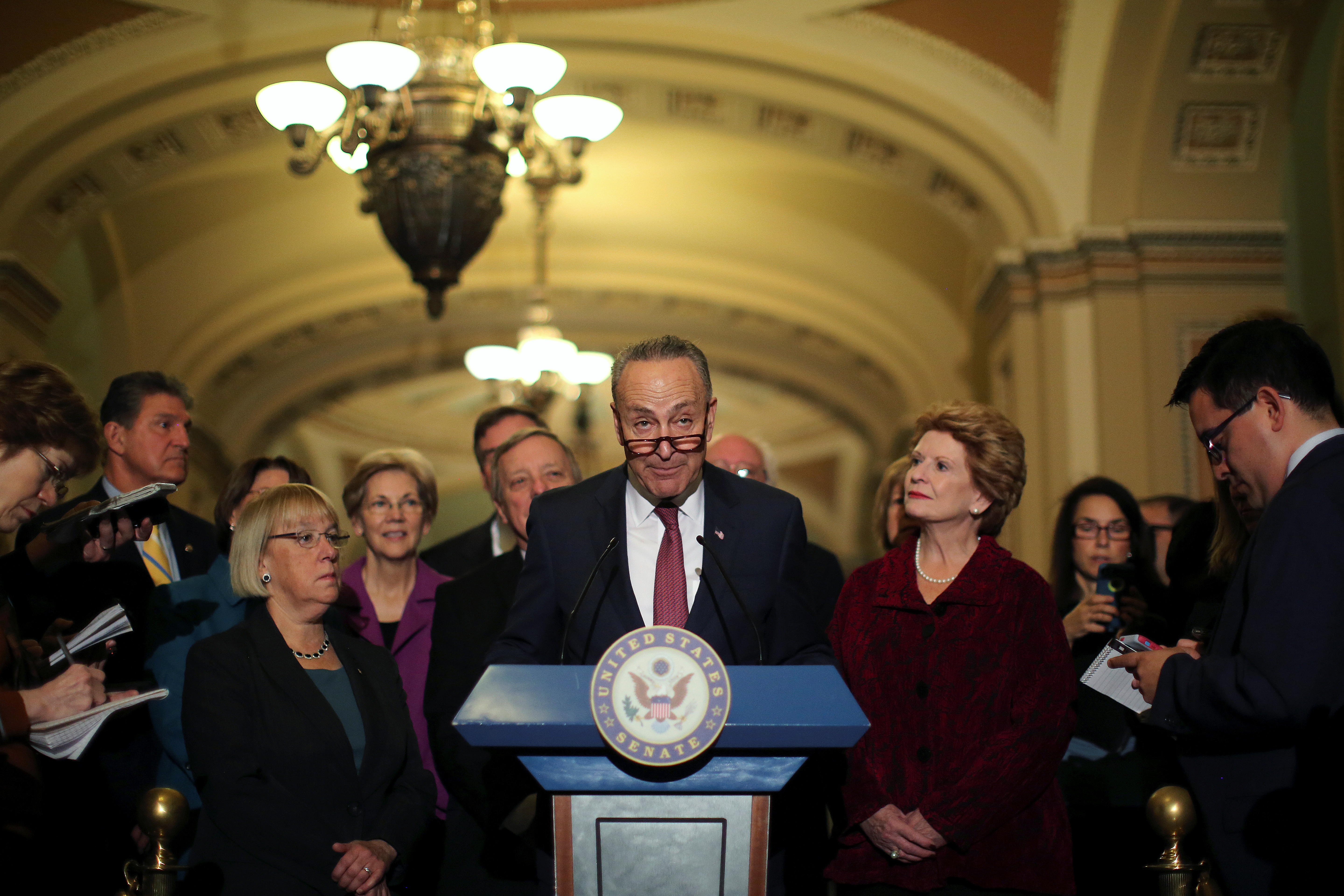 Senator Chuck Schumer (D-NY), flanked by fellow Senate Democrats, talks to journalists after the Senate Democrat party leadership elections in Washington, Nov. 16, 2016.