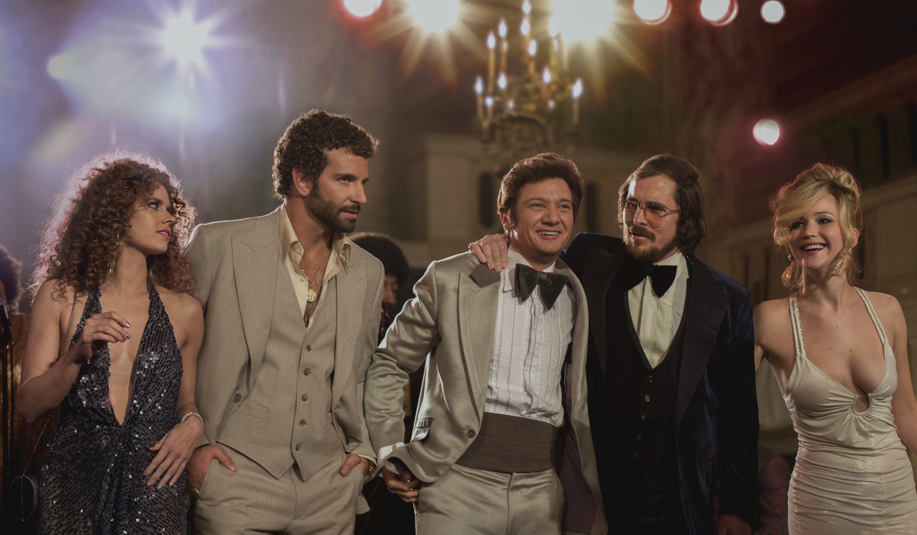 left to right; Amy Adams, as Sydney Prosser, Bradley Cooper, as Richie Dimaso , Jeremy Renner, as Mayor Carmine Polito, Christian Bale as Irving Rosenfeld, and Jennifer Lawrence as Rosalyn Rosenfeld, in a scene from "American Hustle."