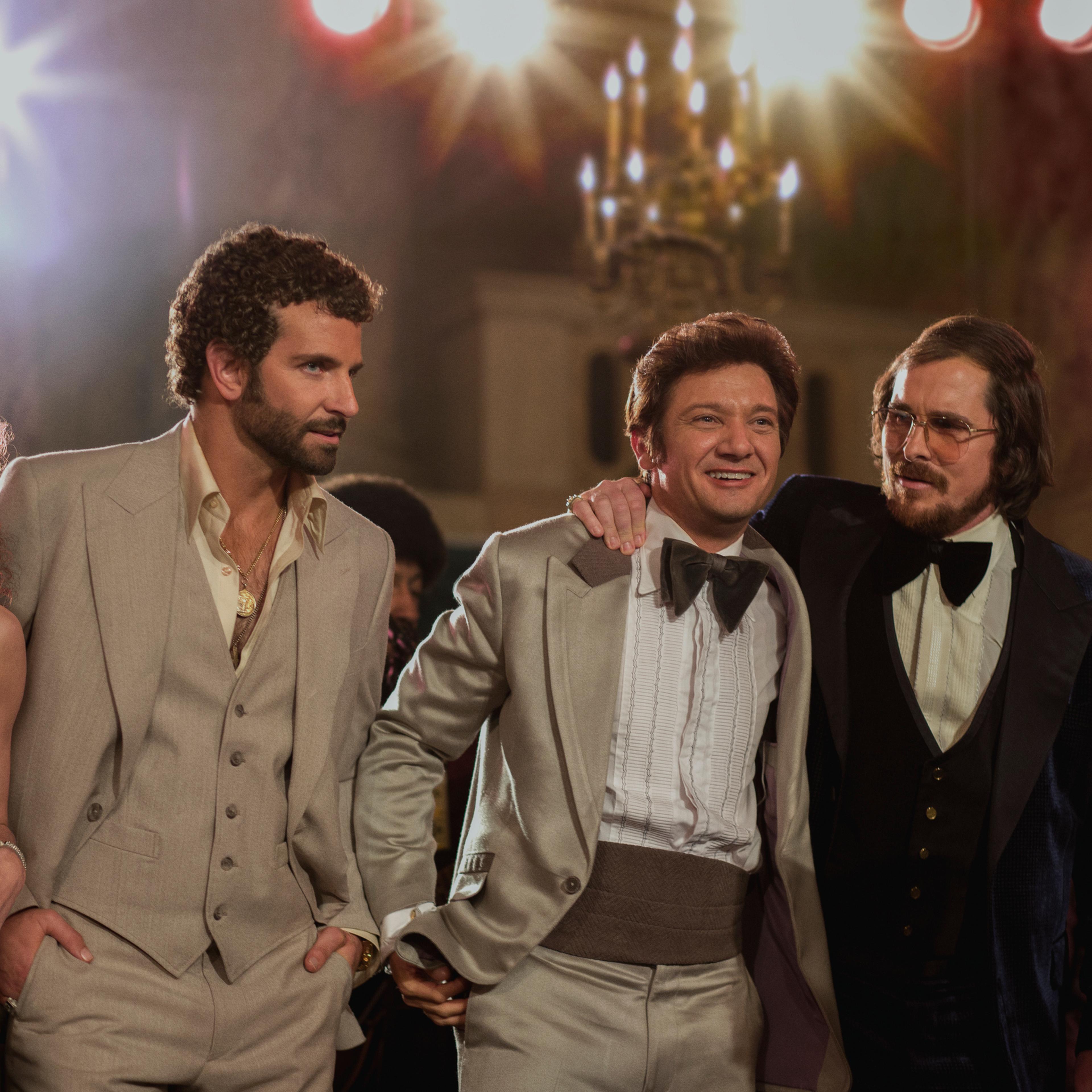left to right; Amy Adams, as Sydney Prosser, Bradley Cooper, as Richie Dimaso , Jeremy Renner, as Mayor Carmine Polito, Christian Bale as Irving Rosenfeld, and Jennifer Lawrence as Rosalyn Rosenfeld, in a scene from "American Hustle."