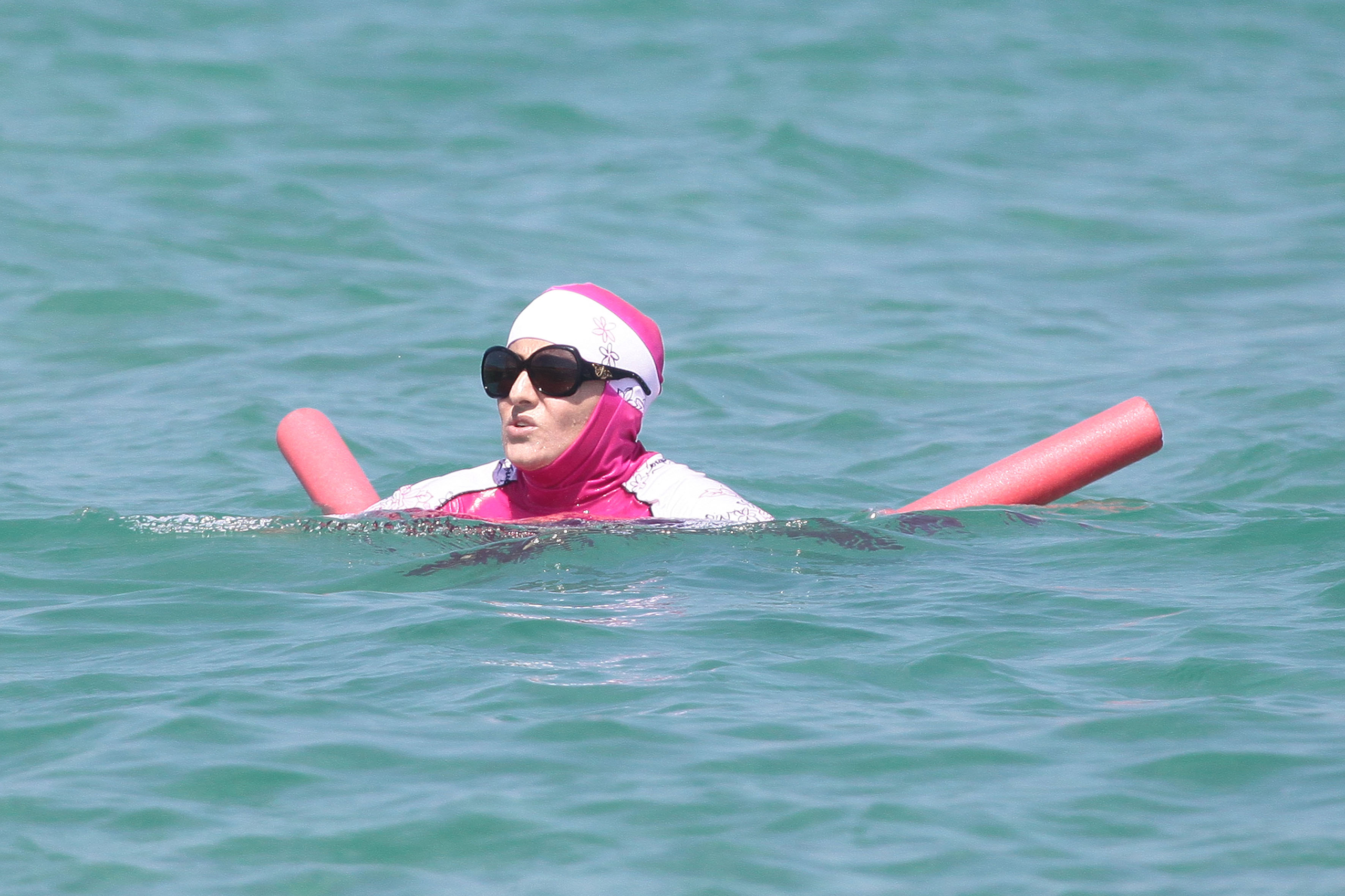 A woman wearing a burkini takes a dip in the south of France on Aug. 15, 2016.