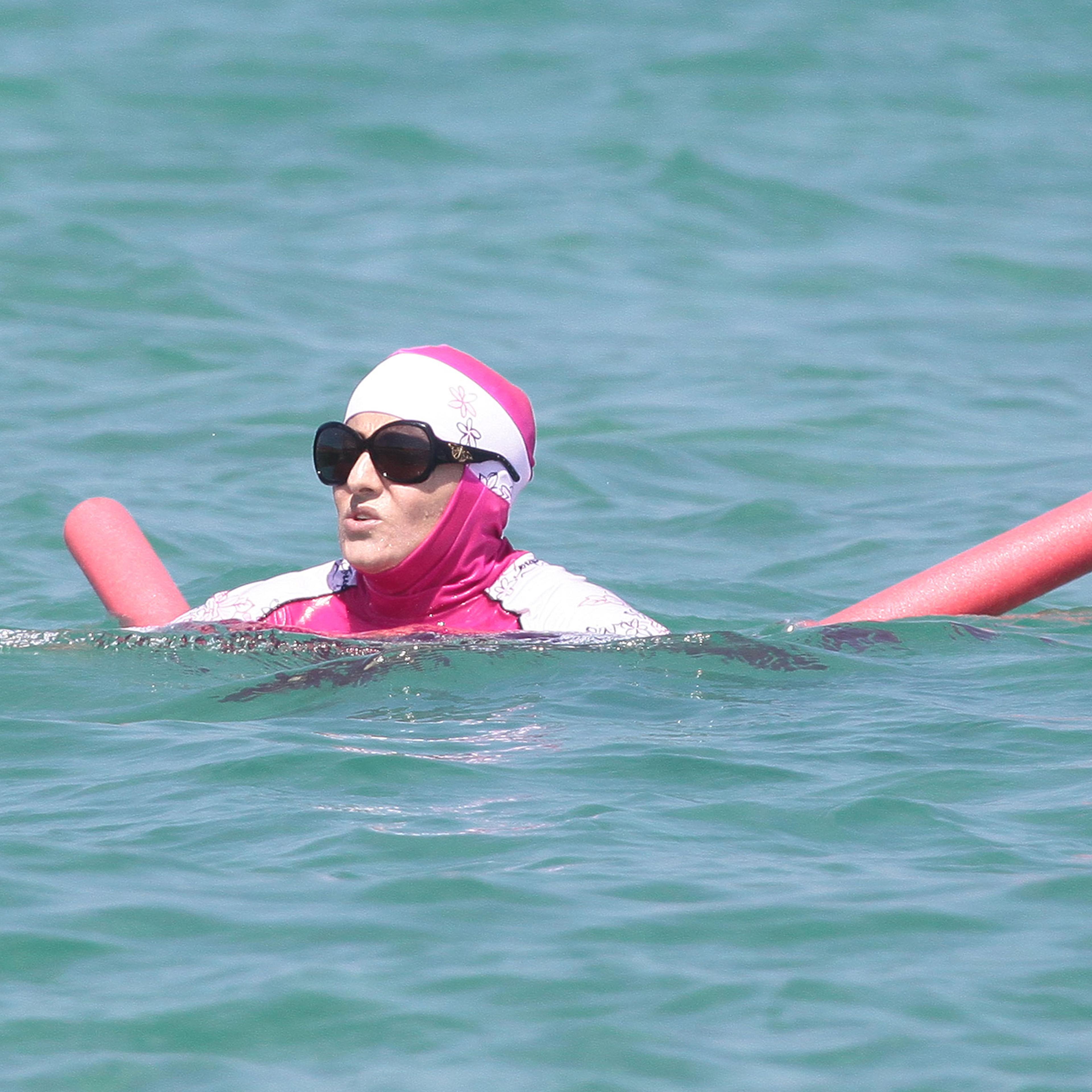 A woman wearing a burkini takes a dip in the south of France on Aug. 15, 2016.