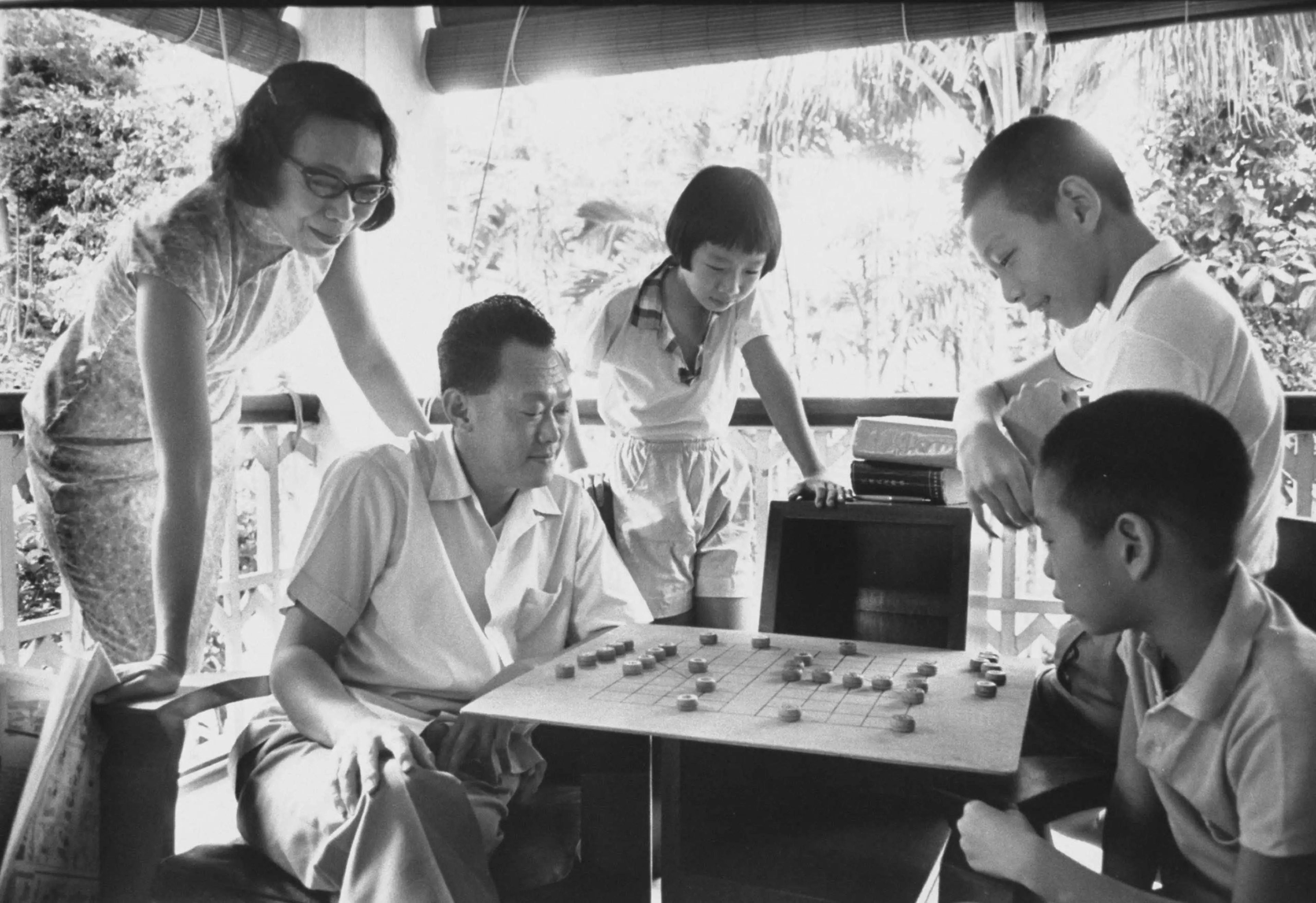 Prime Minister Lee Kuan Yew at home with his family playing Chinese chess in 1965.