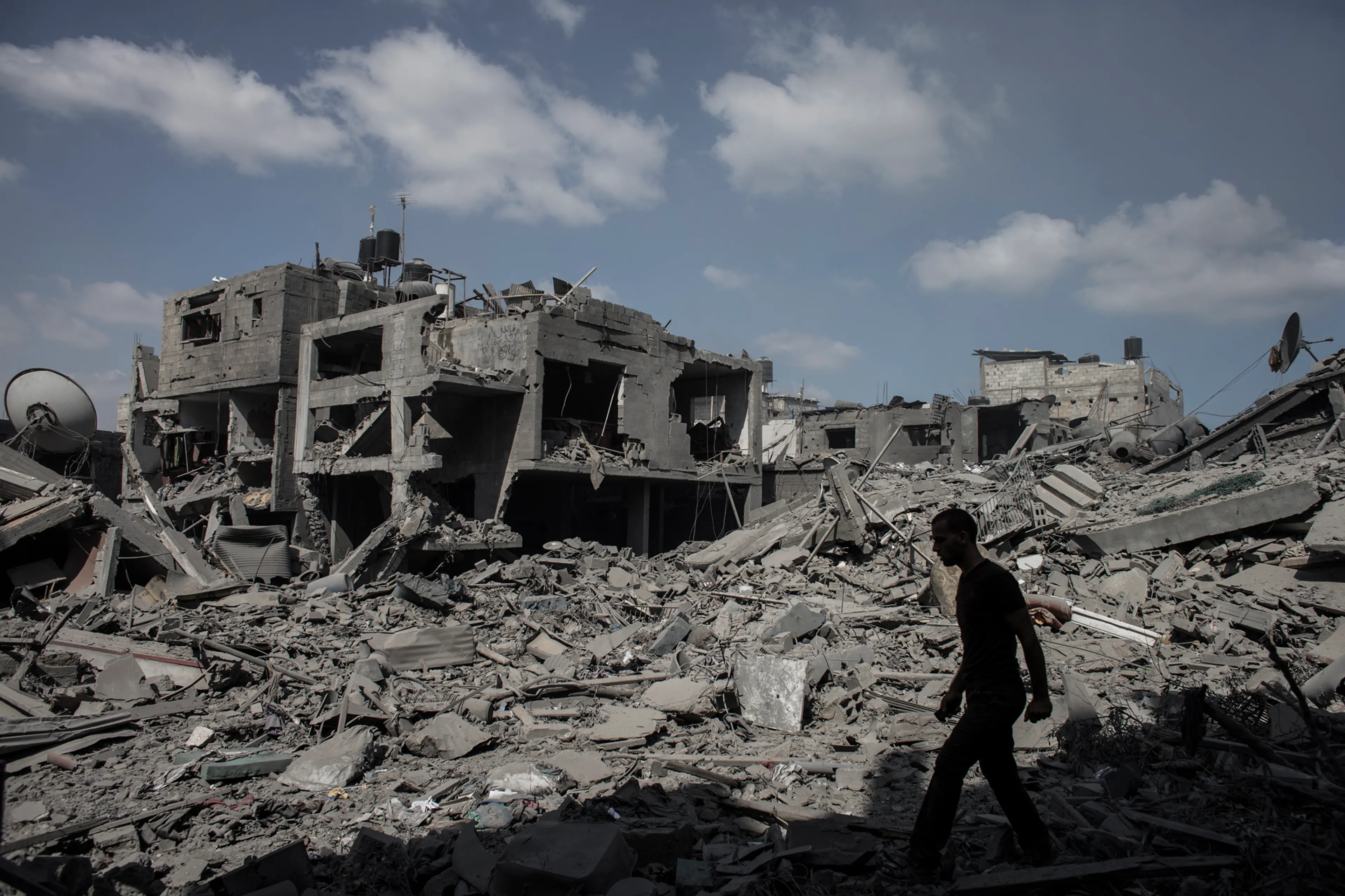 A Palestinian man walks past destroyed houses in Beit Hanoun northern Gaza Strip, July 26 2014.
