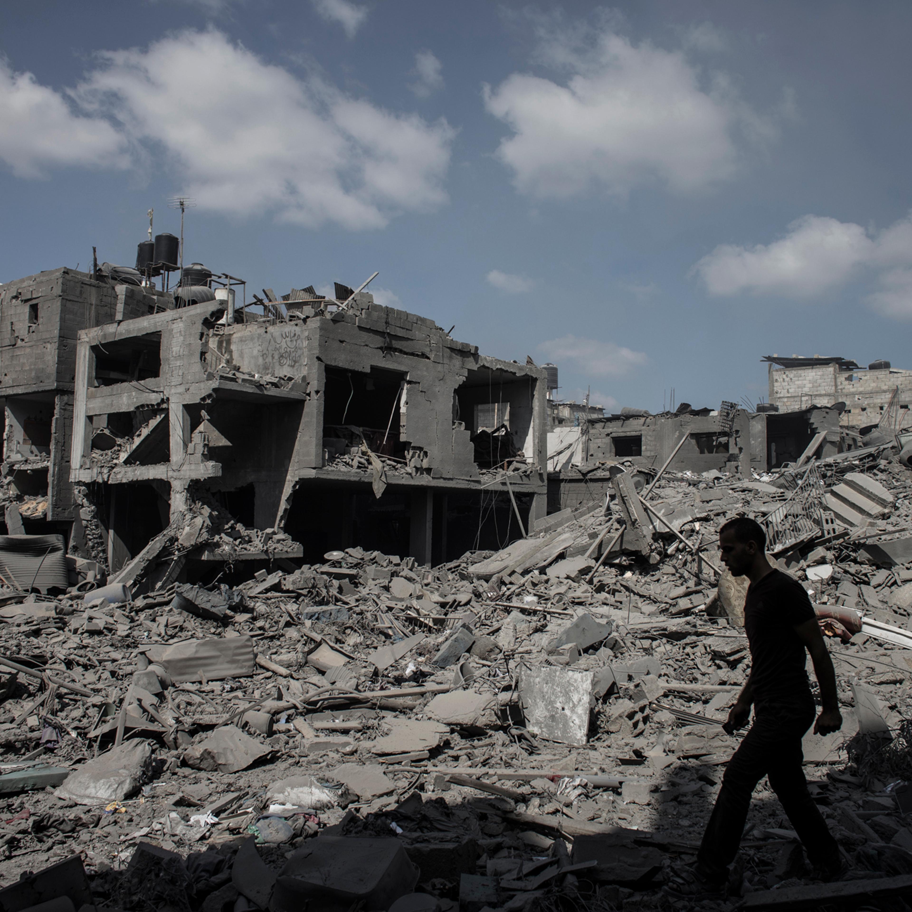 A Palestinian man walks past destroyed houses in Beit Hanoun northern Gaza Strip, July 26 2014.