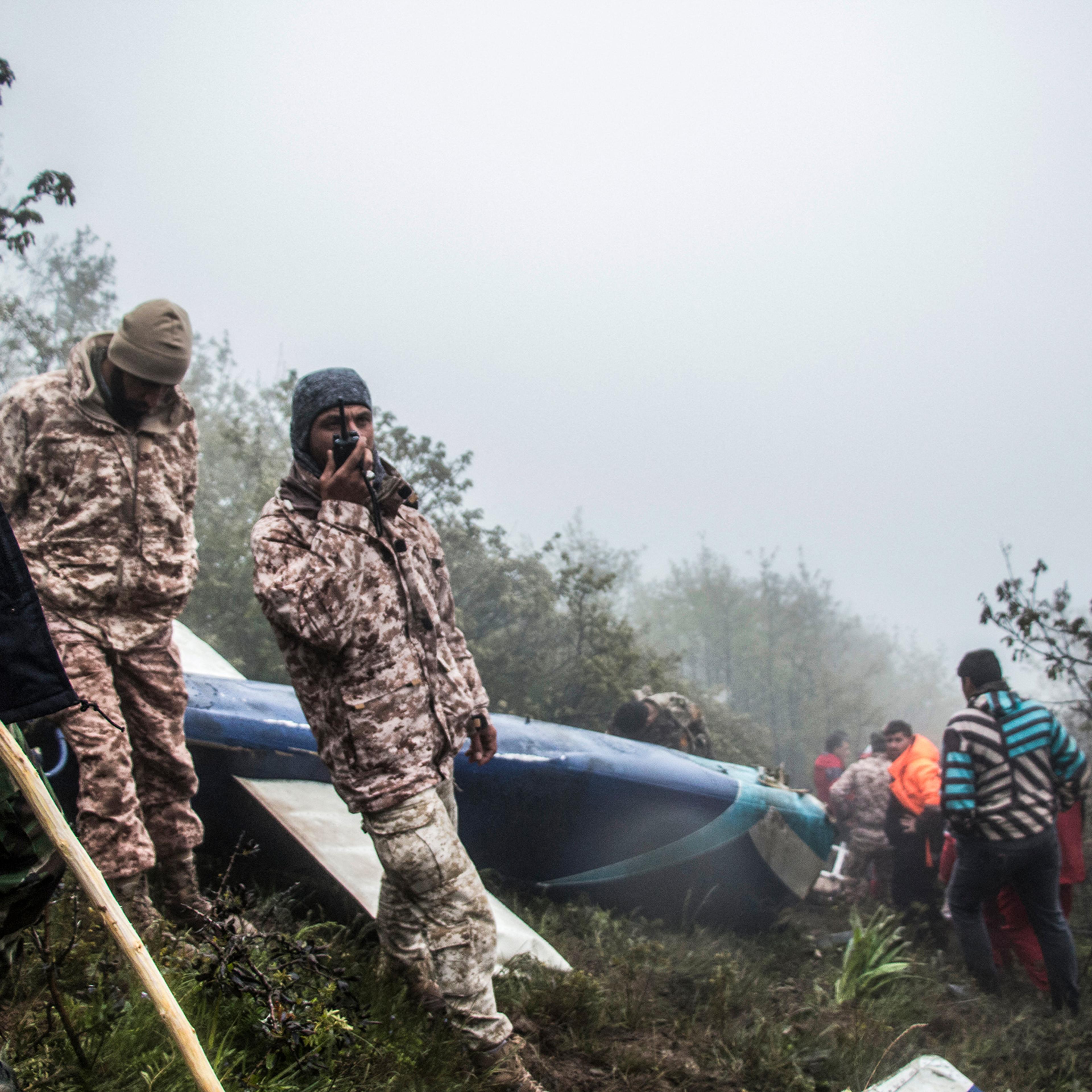 Rescue team members work at the crash site of a helicopter carrying Iranian President Ebrahim Raisi in Varzaghan, northwestern Iran, on May 20, 2024.