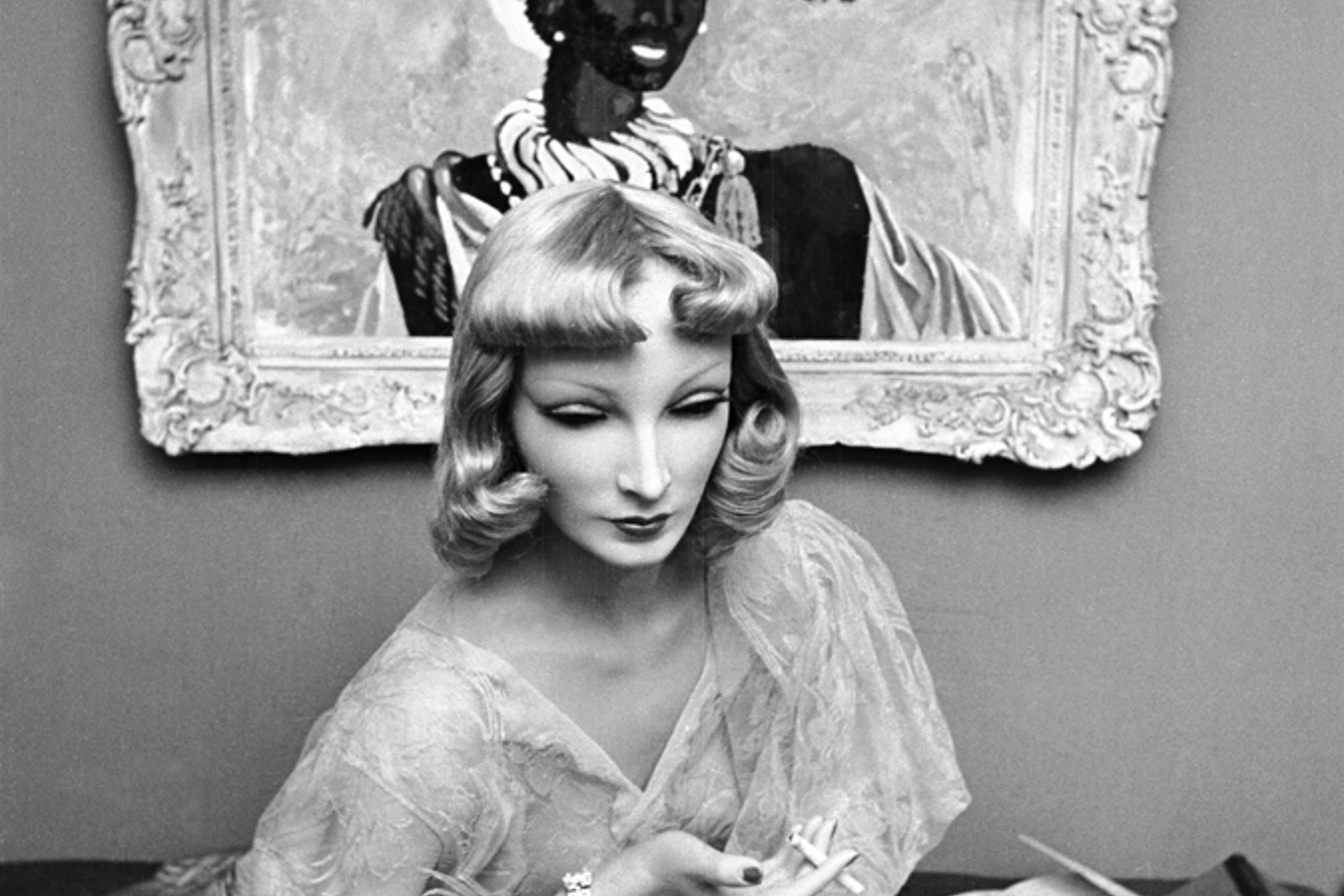 Cynthia the mannequin relaxes at Lester Gaba's apartment in New York in 1937. One of Gaba's paintings is behind her on the wall.