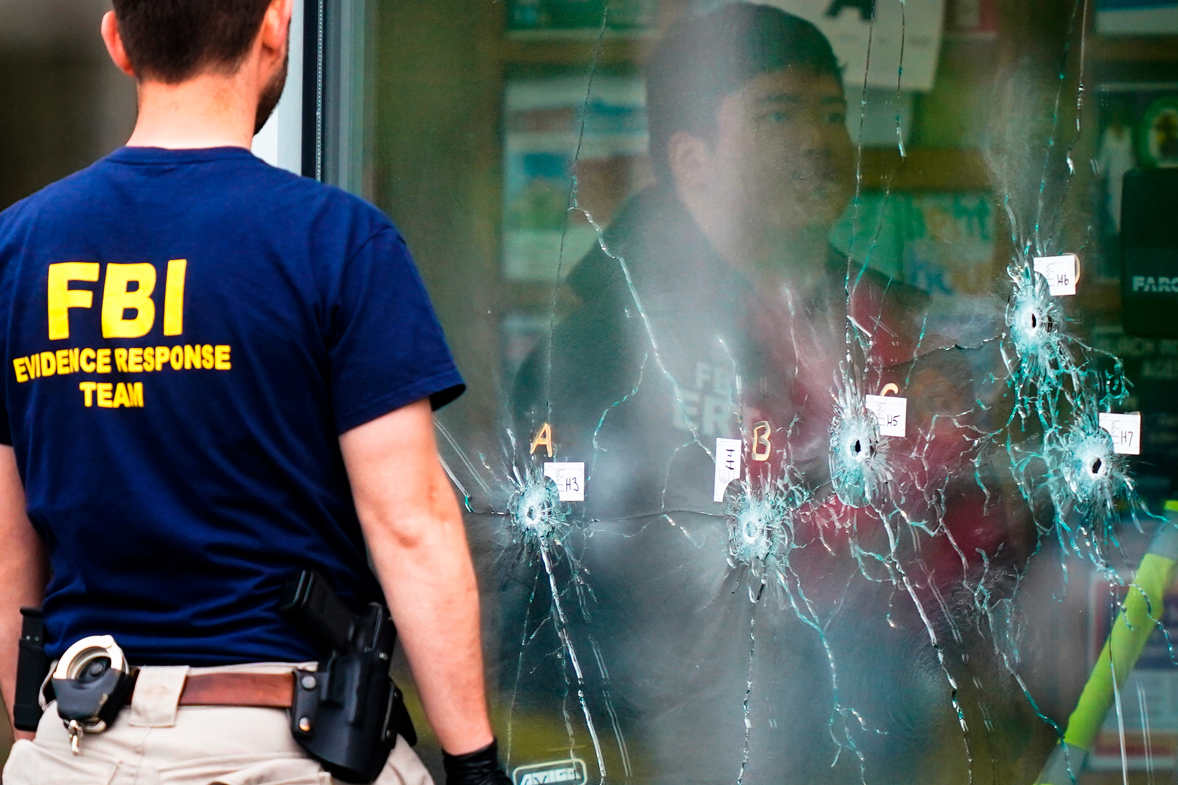 Investigators work the scene of a shooting at a Tops supermarket in Buffalo, N.Y., May 16.