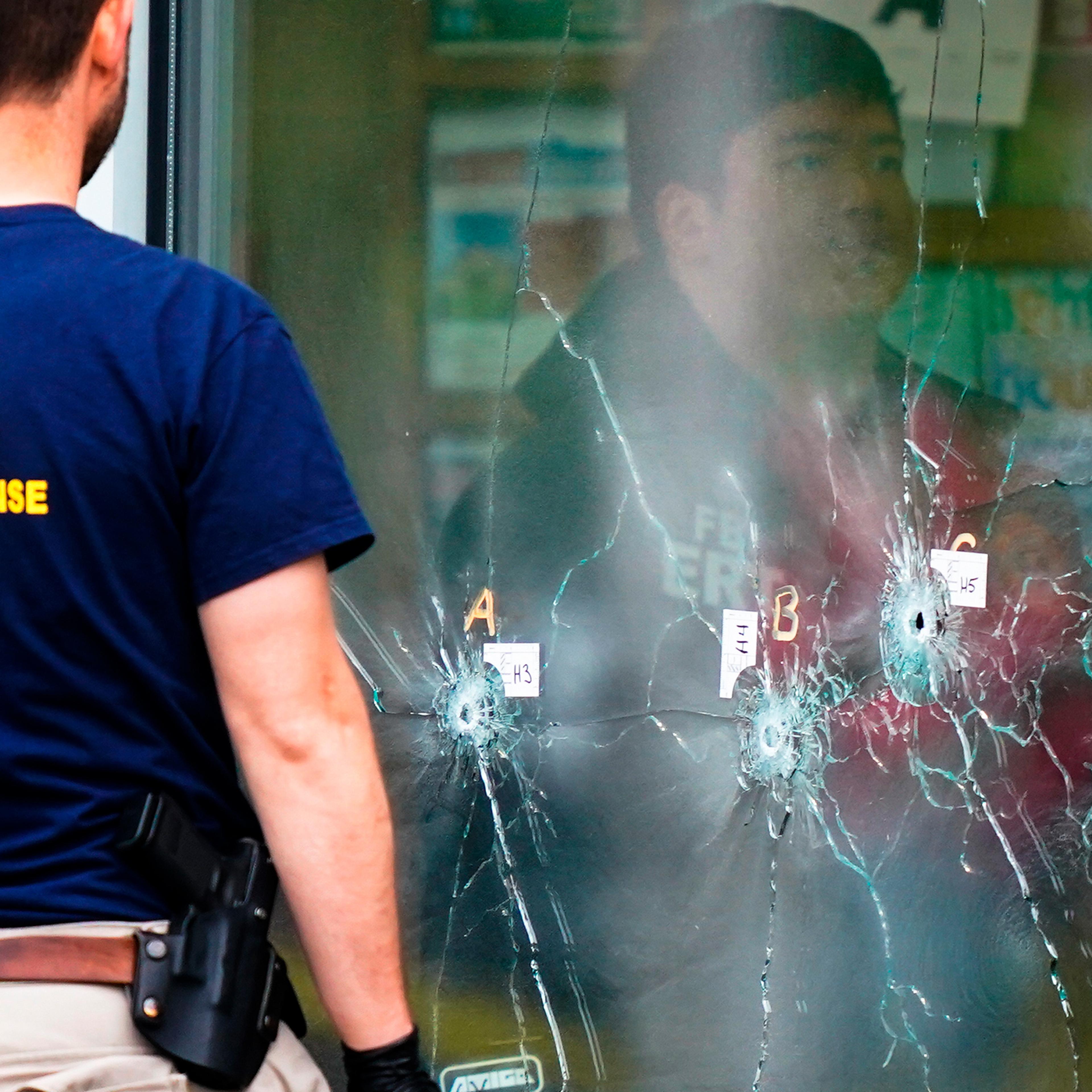 Investigators work the scene of a shooting at a Tops supermarket in Buffalo, N.Y., May 16.