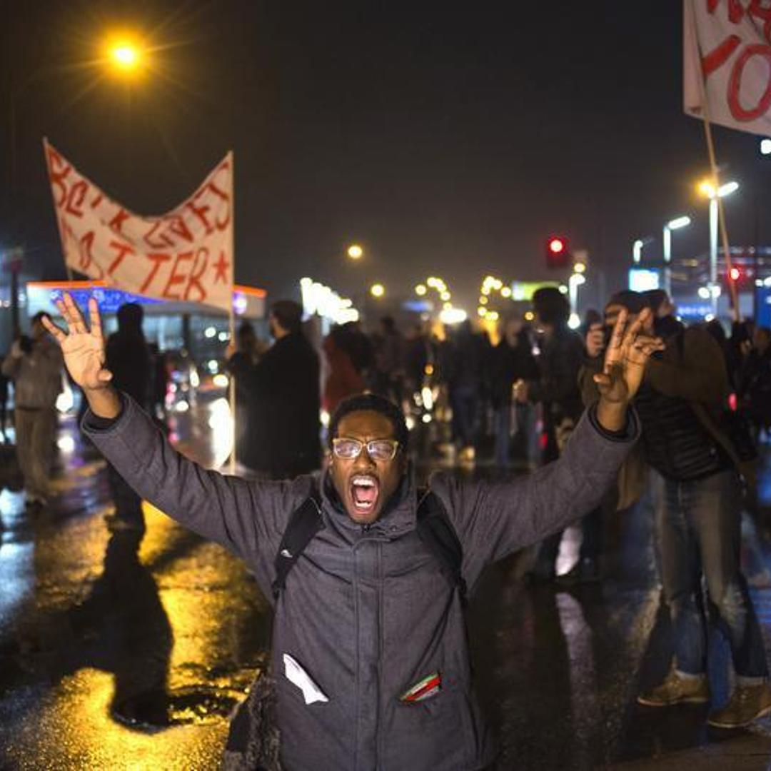A protester, demanding the criminal indictment of a white police officer who shot dead an unarmed black teenager in August, shouts slogans while stopping traffic while marching through a suburb in St. Louis, Missouri