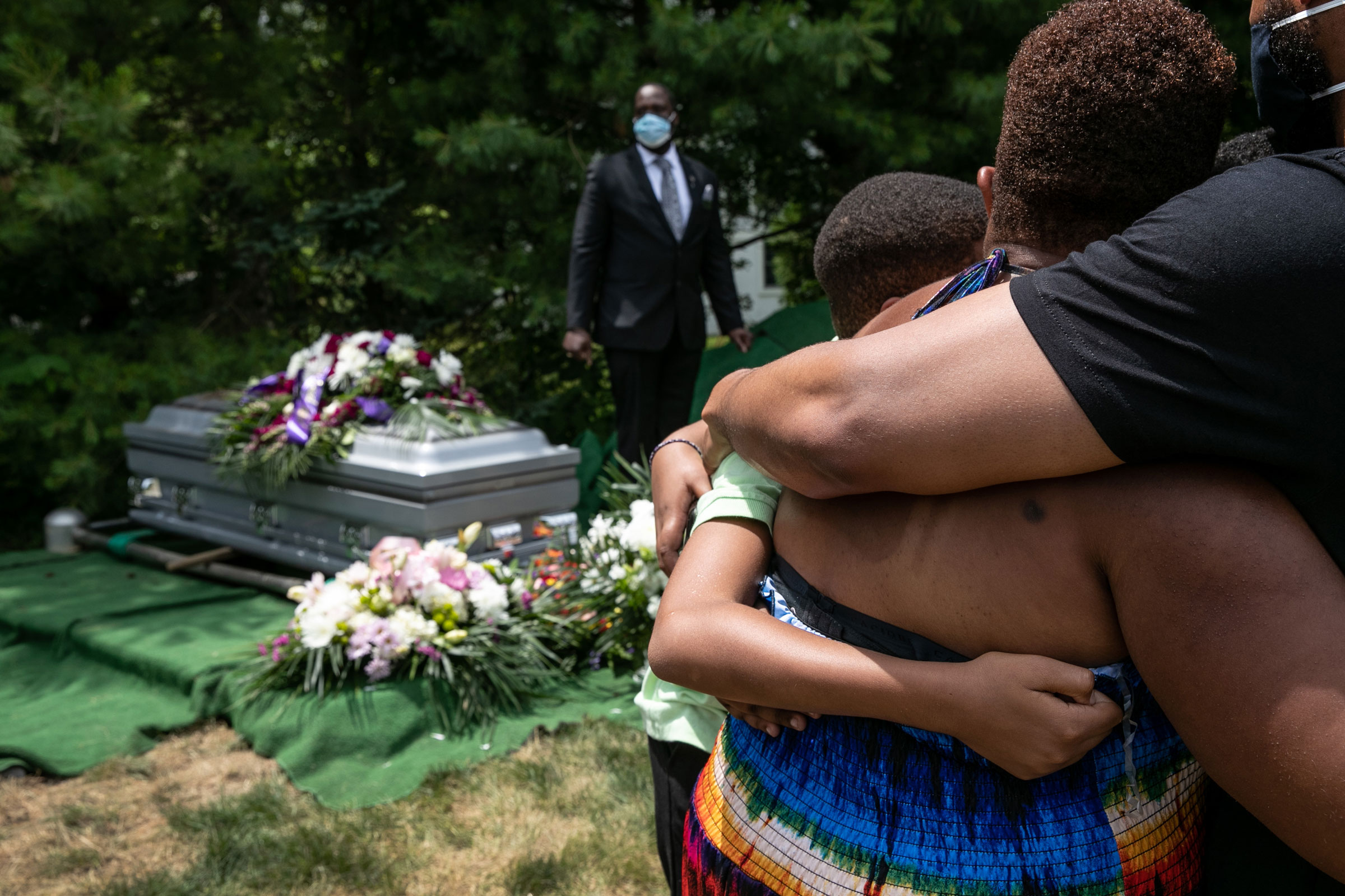 Family members and friends mourn the death of Conrad Coleman Jr. at his burial service