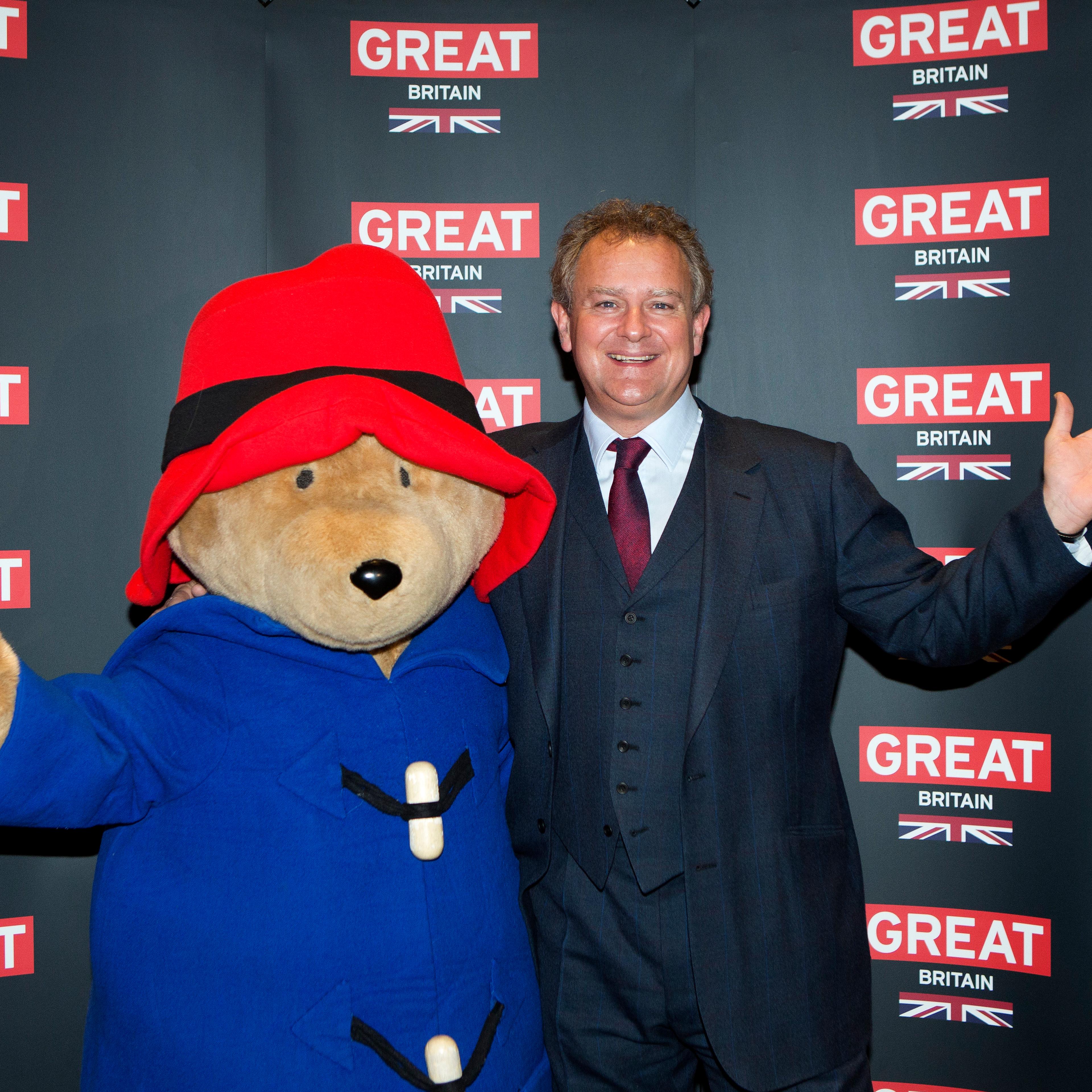 Actor Hugh Bonneville poses with a person dressed as Paddington Bear during the photo call for the film Paddington Bear at The British Embassy in Berlin, during the International Film Festival Berlinale, Feb. 7, 2014.