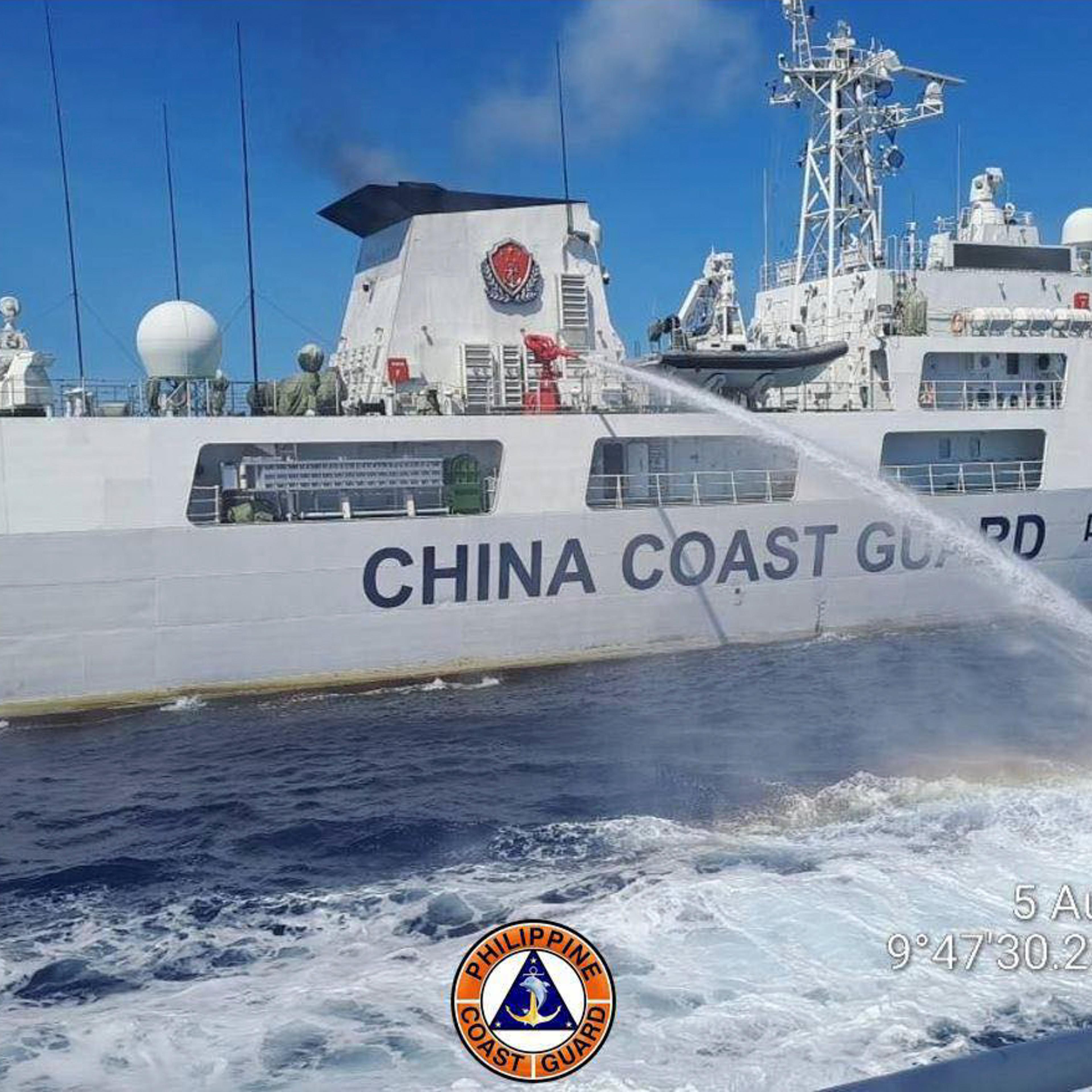 In this handout photo provided by the Philippine Coast Guard, a Chinese coast guard ship uses water canons on a Philippine Coast Guard ship near the Philippine-occupied Second Thomas Shoal, South China Sea as they blocked it's path during a re-supply mis