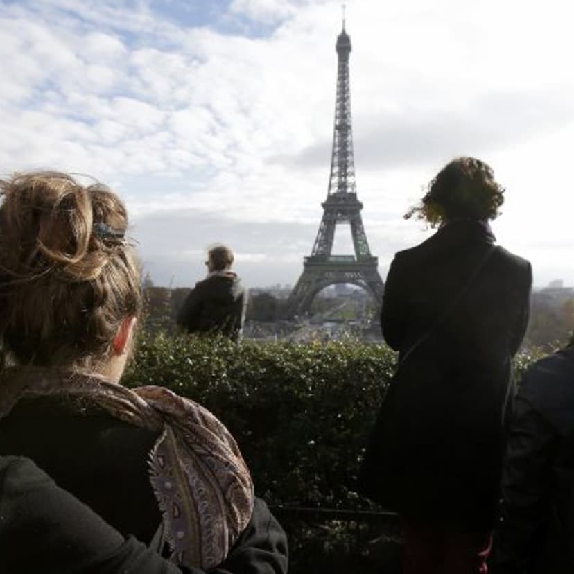 Mourners observe a minute of silence at the Trocadero in front the Eiffel Tower to pay tribute to the victims of the attacks on Paris.