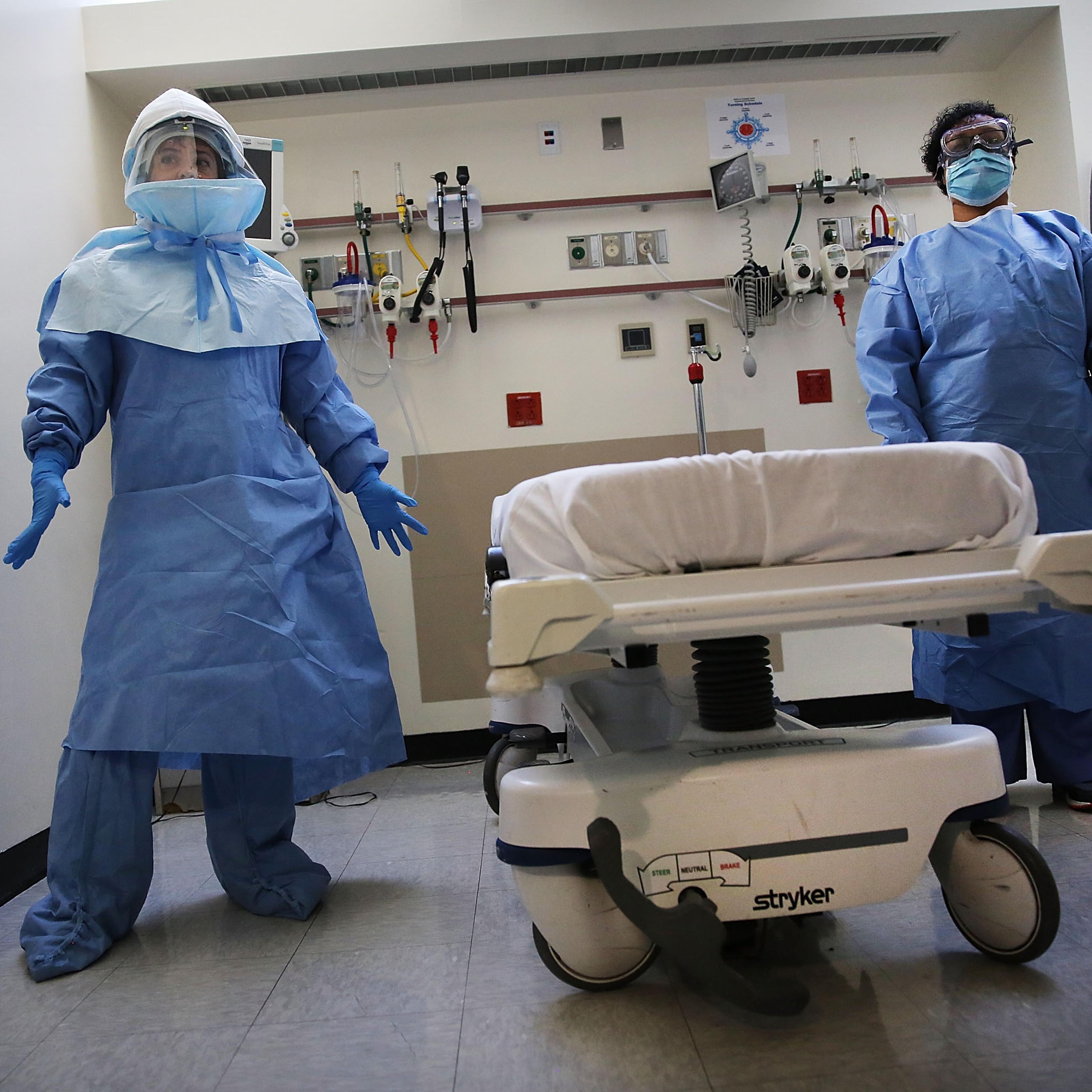 Members of Bellevue Hospital staff wear protective clothing as they demonstrate how they would receive a suspected Ebola patient on Oct. 8, 2014 in New York City.