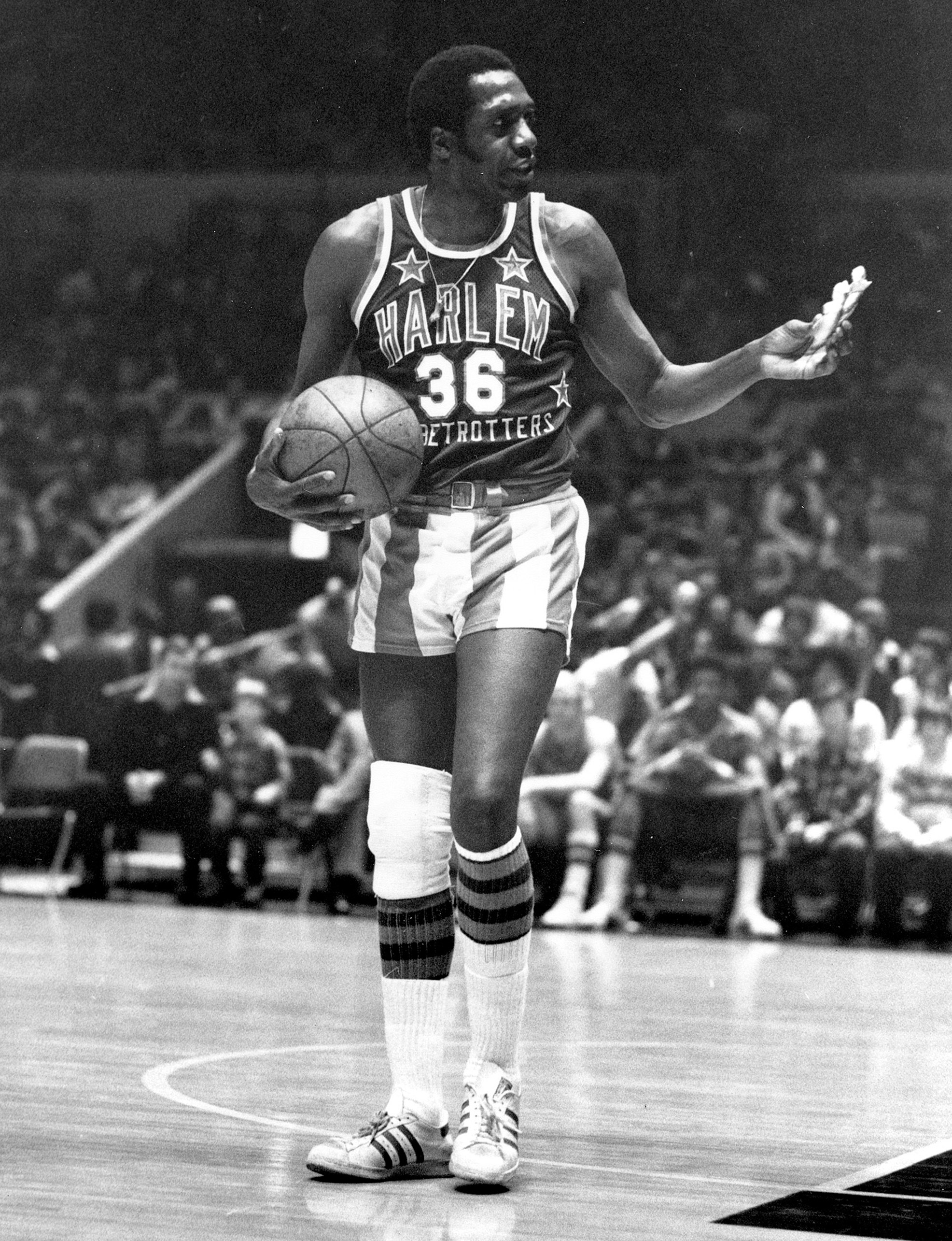 FILE - In this Feb. 18, 1978, file photo, Meadowlark Lemon, of the Harlem Globetrotters basketball team, offers a pretzel to a referee during a game at New York's Madison Square Garden. Lemon, known as the Globetrotters' "clown prince" of basketball, die