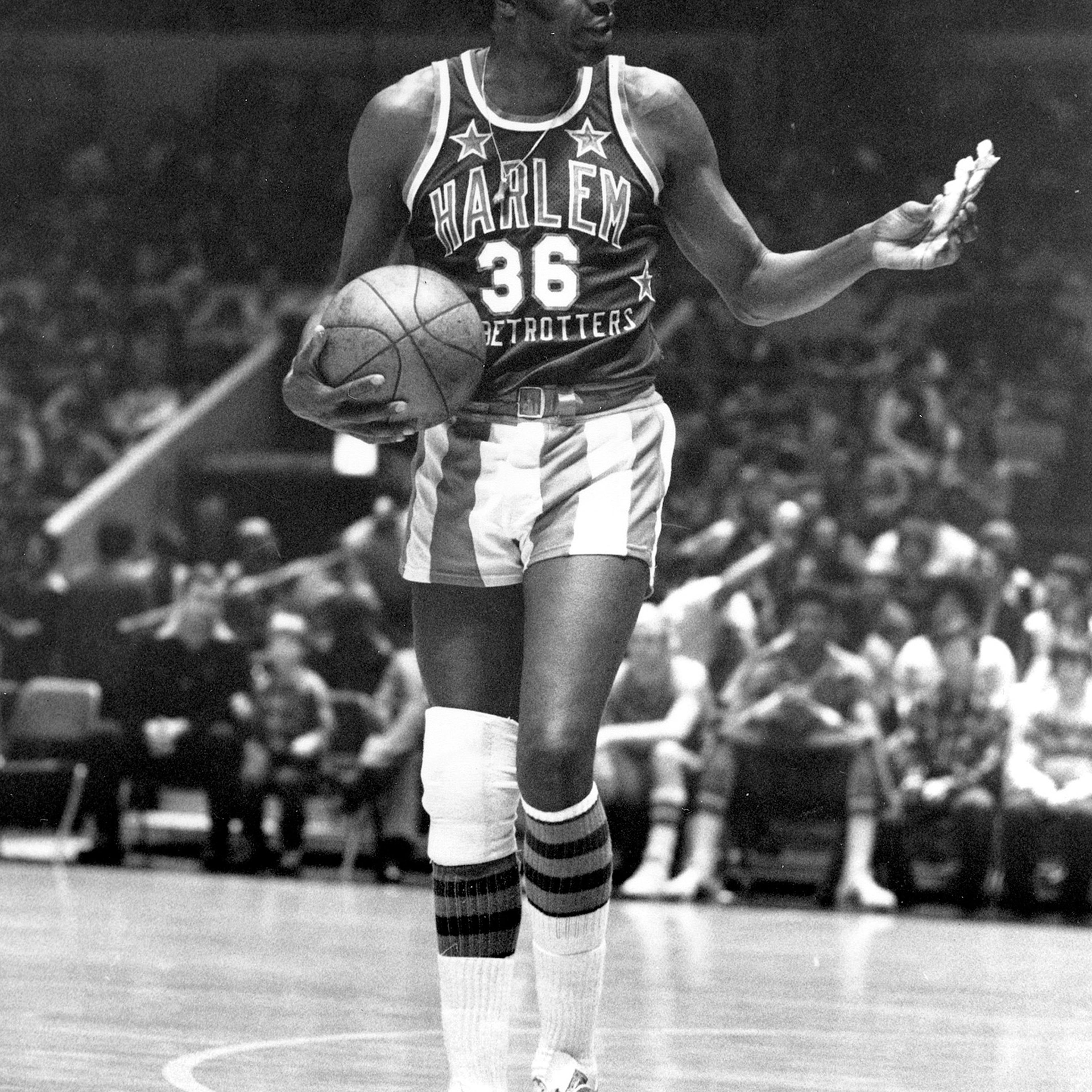 FILE - In this Feb. 18, 1978, file photo, Meadowlark Lemon, of the Harlem Globetrotters basketball team, offers a pretzel to a referee during a game at New York's Madison Square Garden. Lemon, known as the Globetrotters' "clown prince" of basketball, die