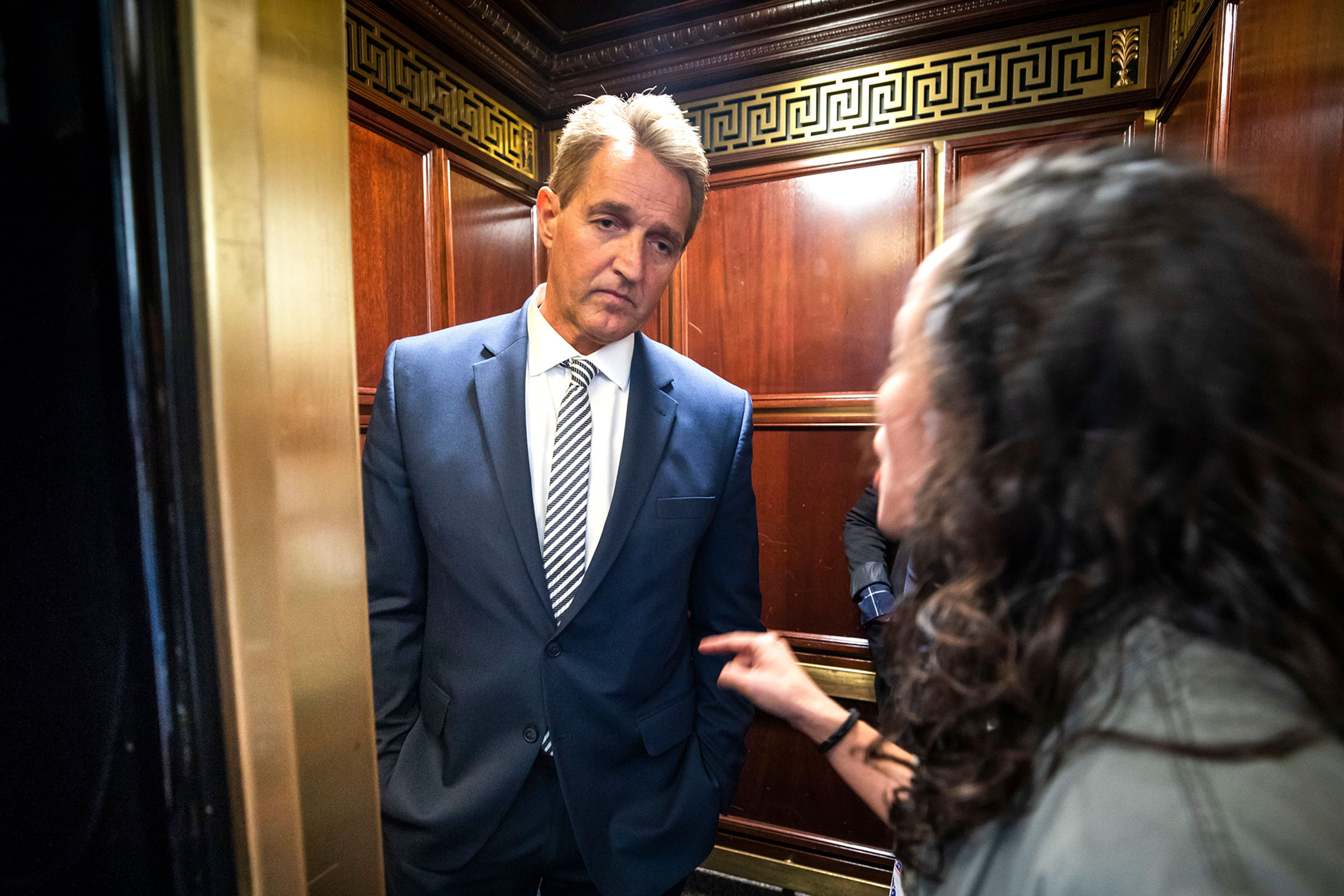 A woman who said she is a survivor of a sexual assault confronts Republican Senator from Arizona Jeff Flake in an elevator after Flake announced that he vote to confirm Supreme Court nominee Brett Kavanaugh on Sept. 28, 2018.