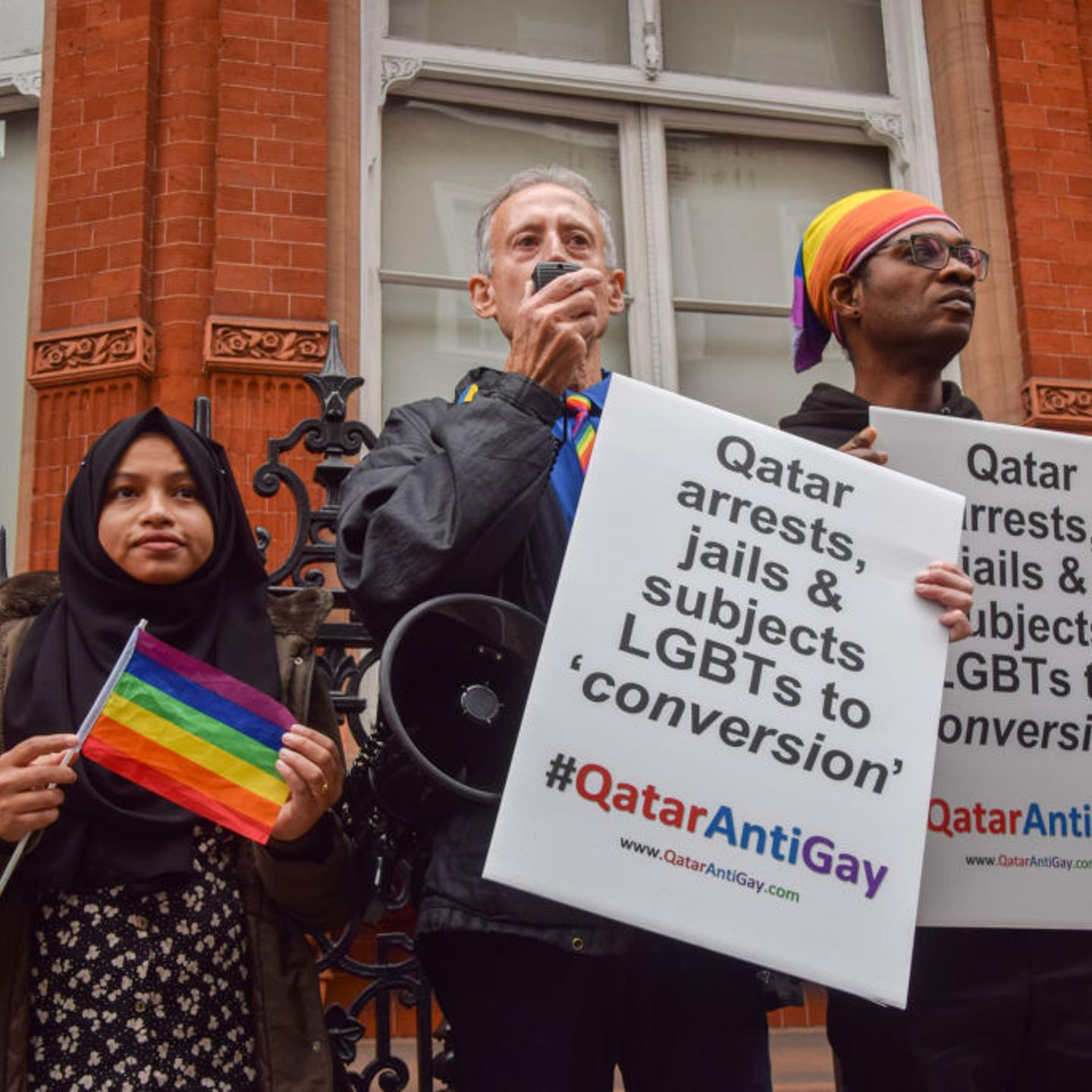 Activist Peter Tatchell holds a placard which states 'Qatar