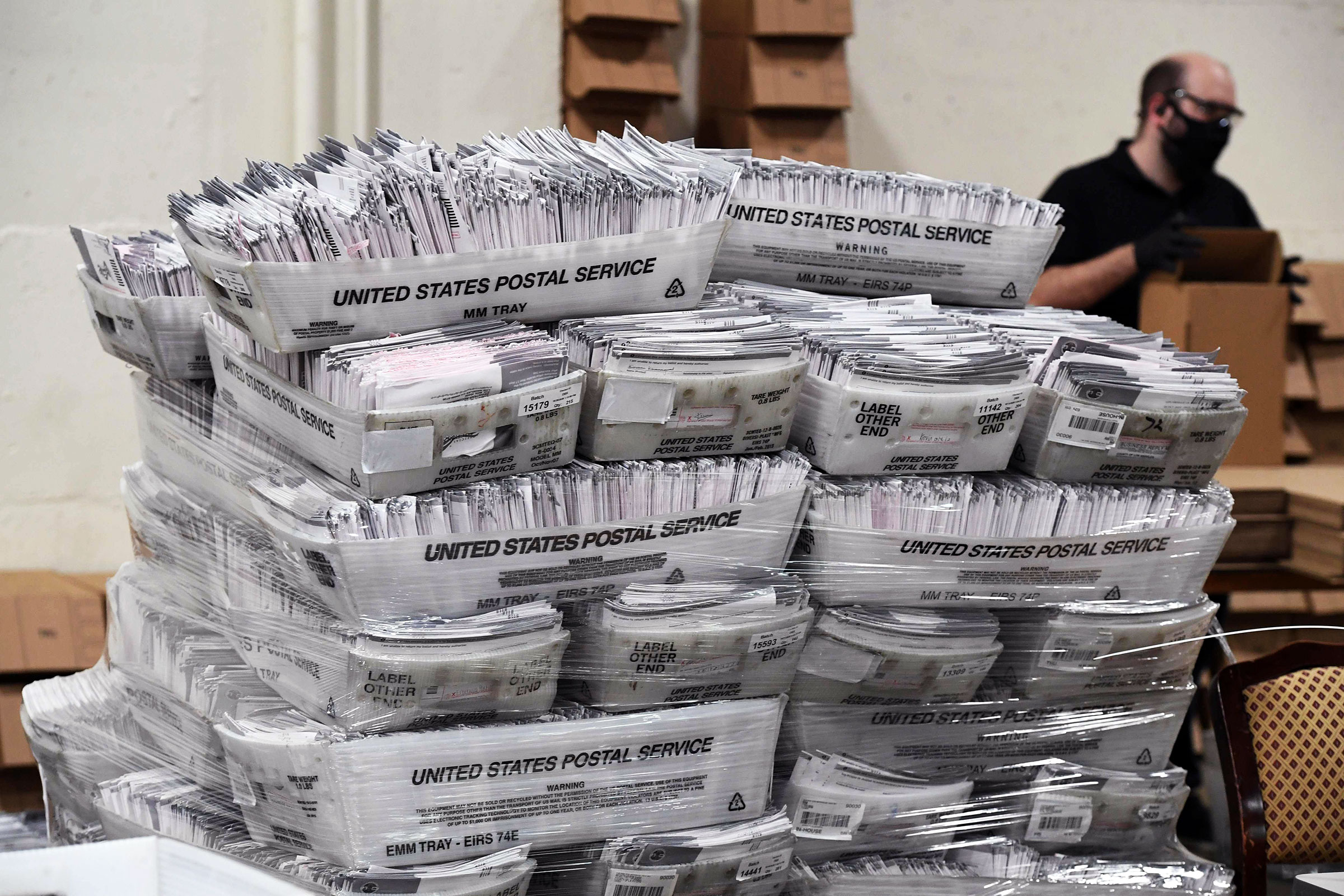 Mail-in ballots in their envelopes await processing at the Los Angeles County Registrar Recorders' mail-in ballot processing center in Pomona, Calif., On Oct. 28, 2020.