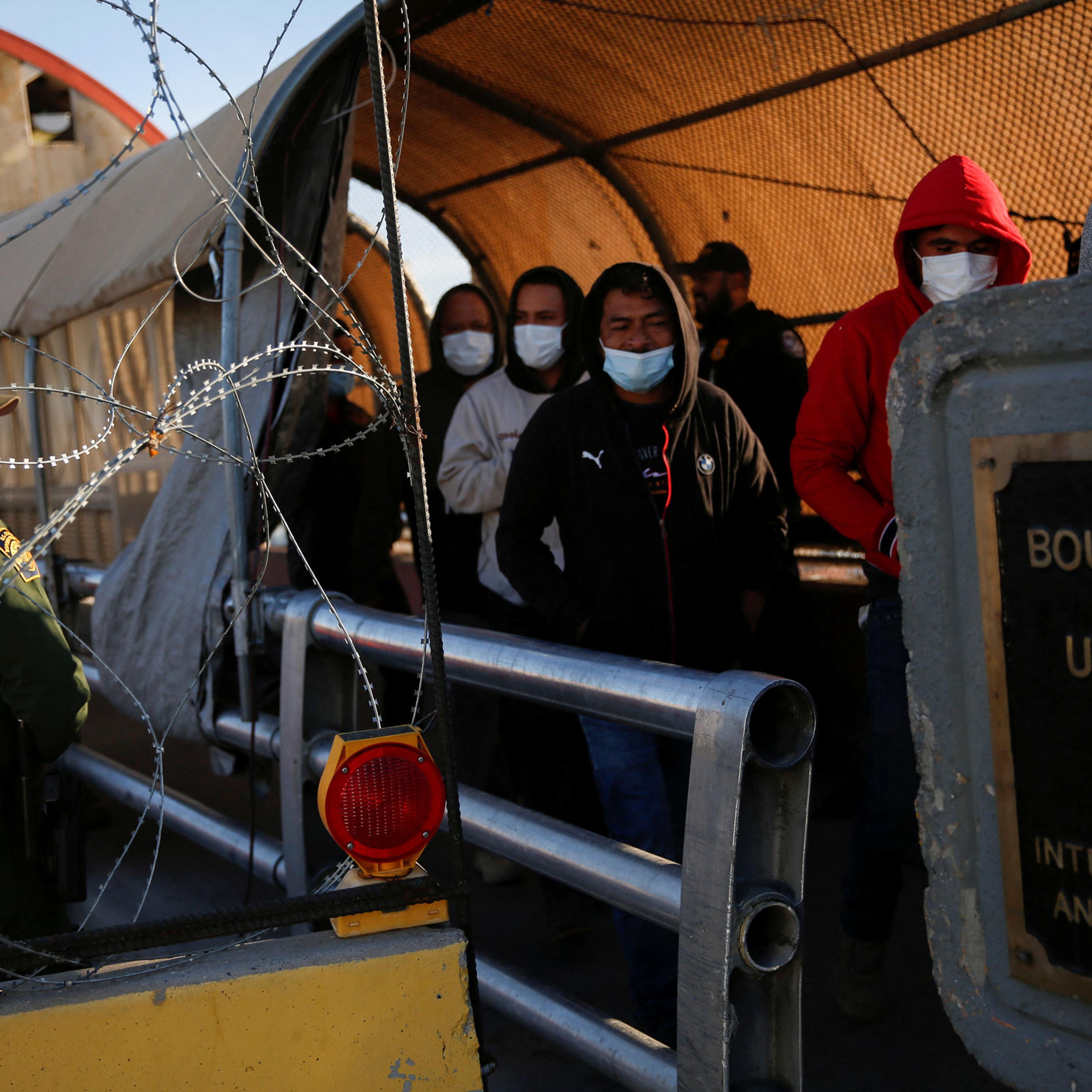 Migrants expelled from the U.S. and sent back to Mexico under Title 42, walk towards Mexico