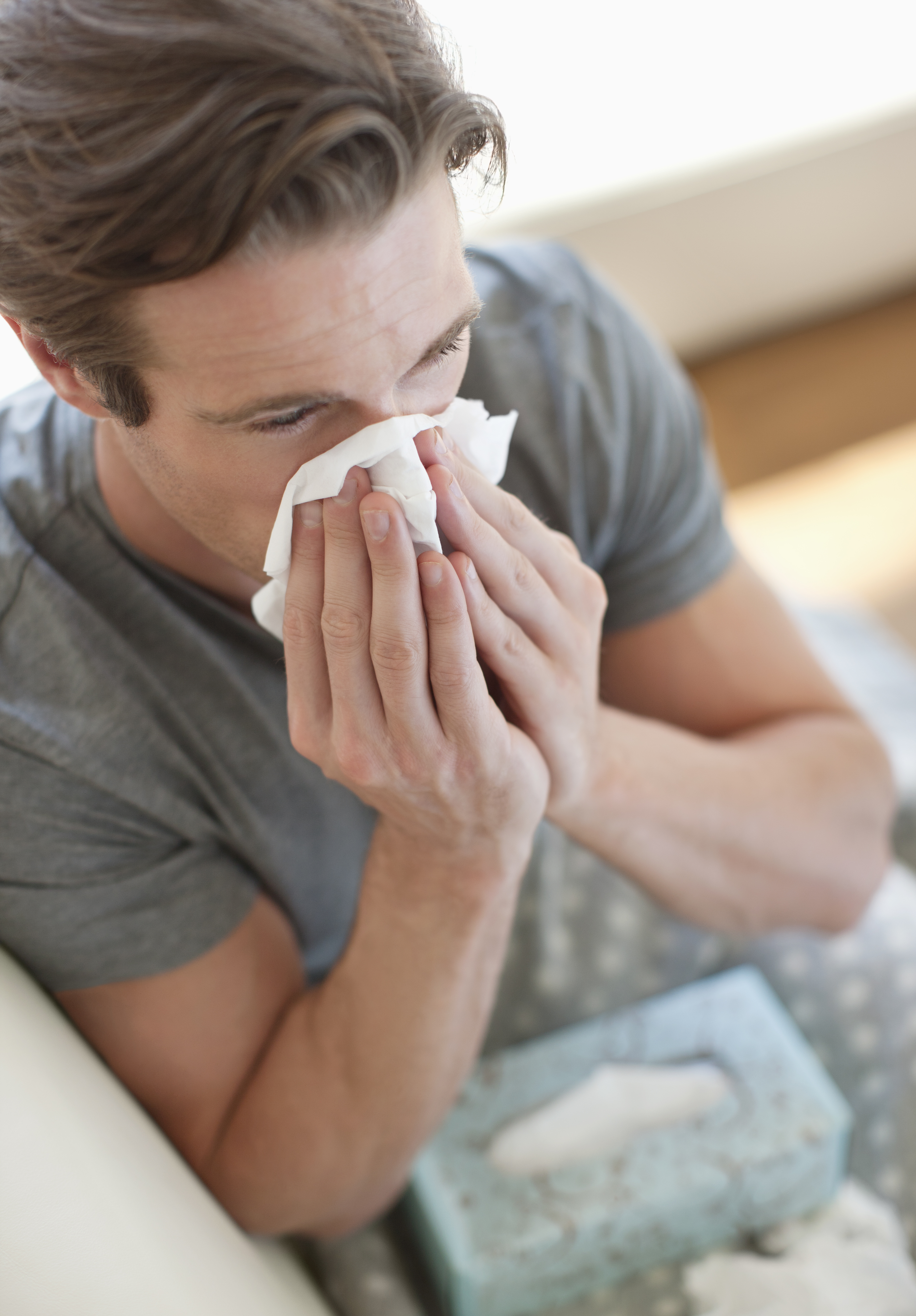 man-blowing-nose