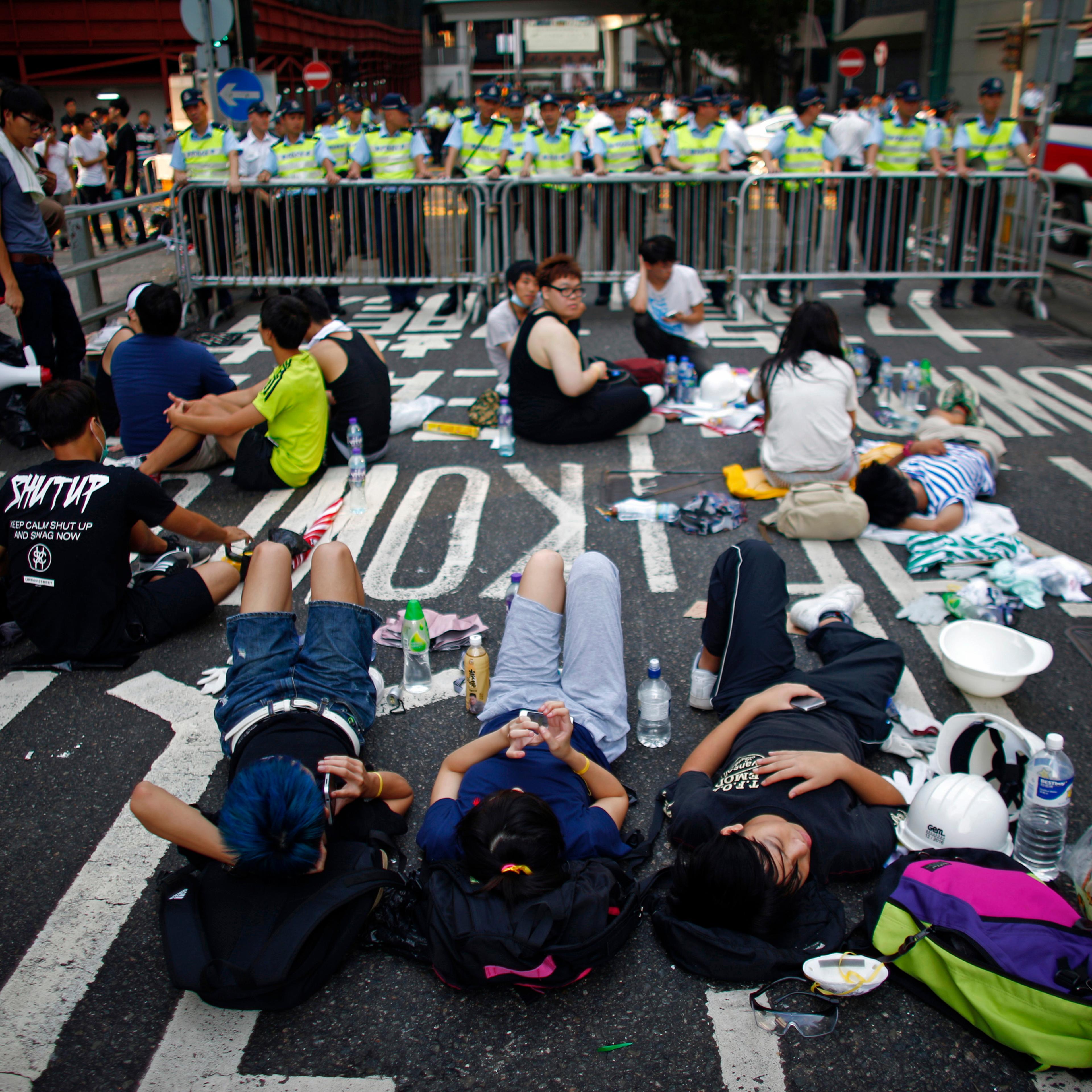 Protesters block a street near government headquarters in Hong Kong