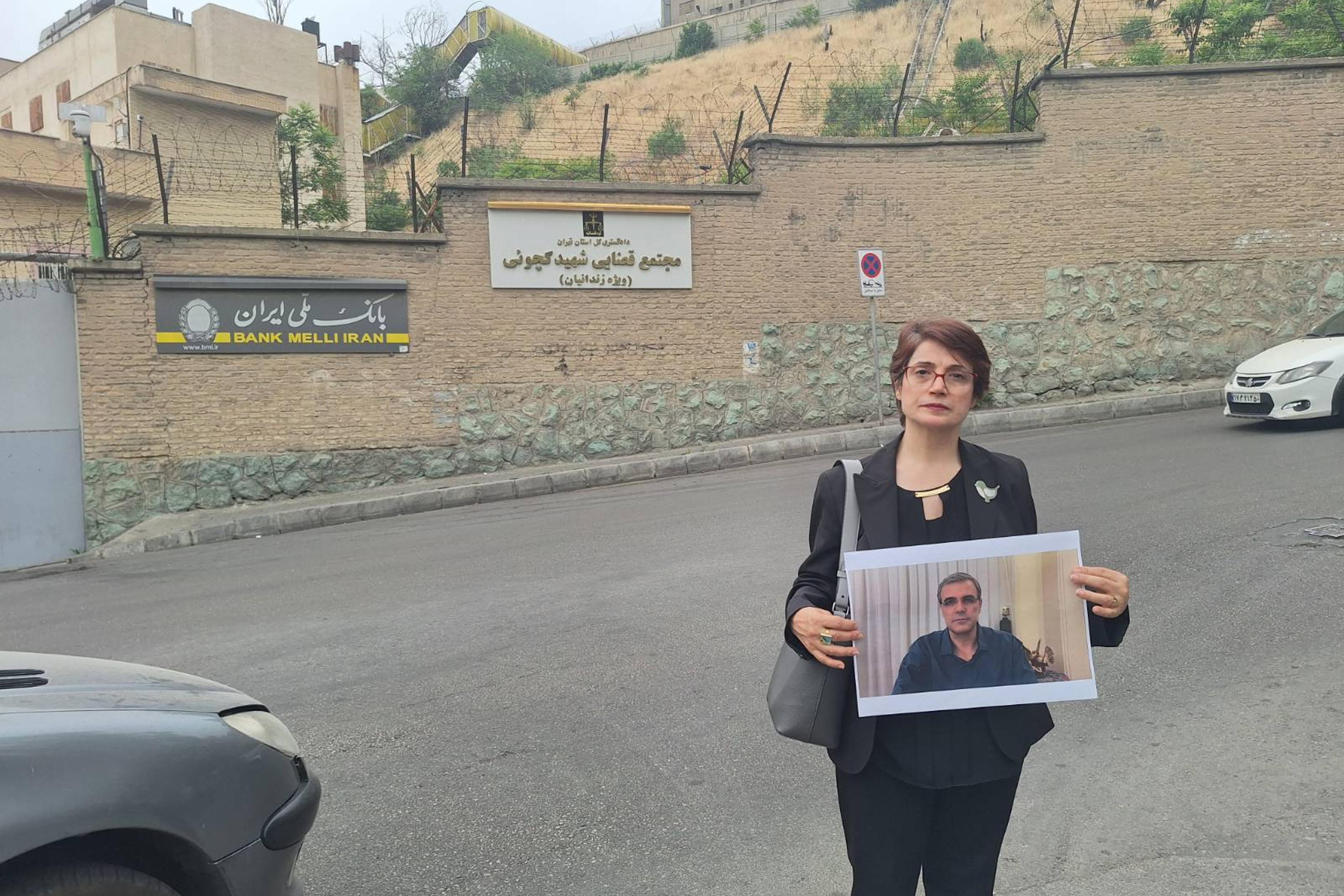 Iranian human rights attorney and activist Nasrin Satoudeh holds a photo of her husband outside Tehran's Evin Prison, where he is an inmate. Reza Khandan was taken into custody in December on charges of making buttons reading "I Oppose the Mandatory Hijab" and otherwise supporting women's rights. His wife has spent six years behind bars on similar charges. "Today was the day I’m supposed to be able to meet Reza," she said, "but as usual they prevented me from seeing him because I wasn't wearing a hijab."