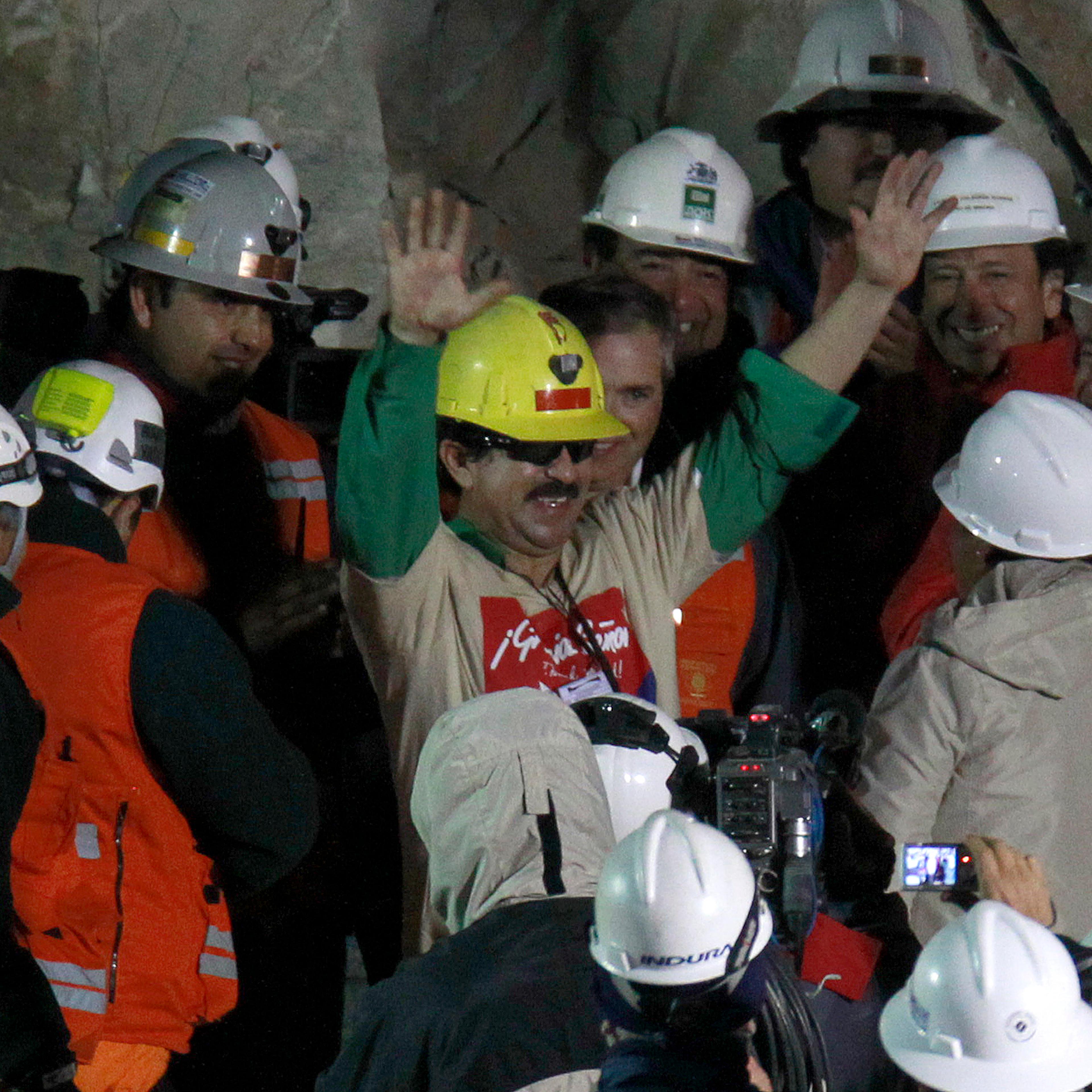 Miner Juan Andres Illanes Palma salutes after being rescued from the collapsed San Jose gold and copper mine near Copiapo, Chile on Oct. 13, 2010.