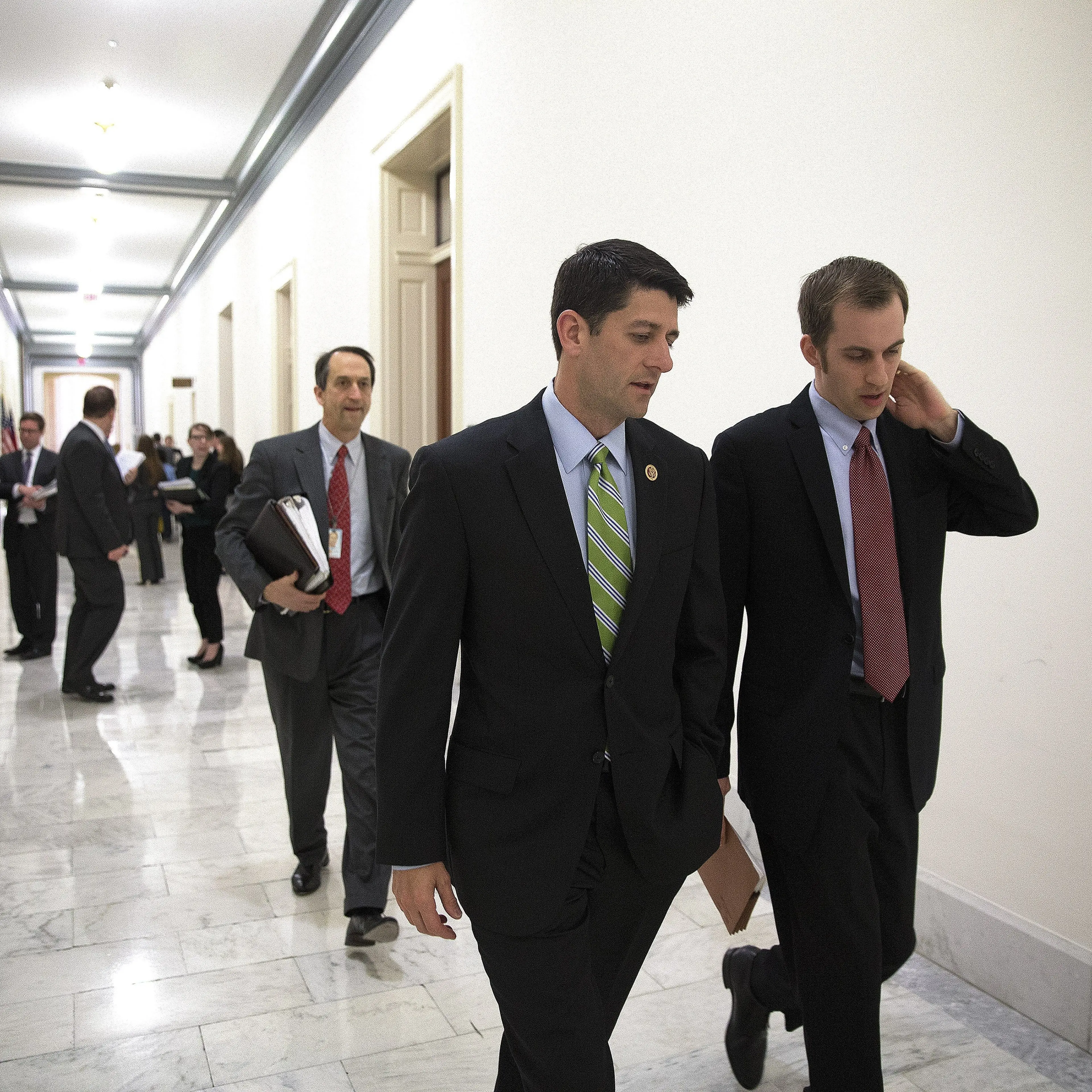 Rep. Paul Ryan, chairman of the House Budget Committee, walks with his staff following a meeting on the newest Republican budget for 2015 on Capitol Hill.