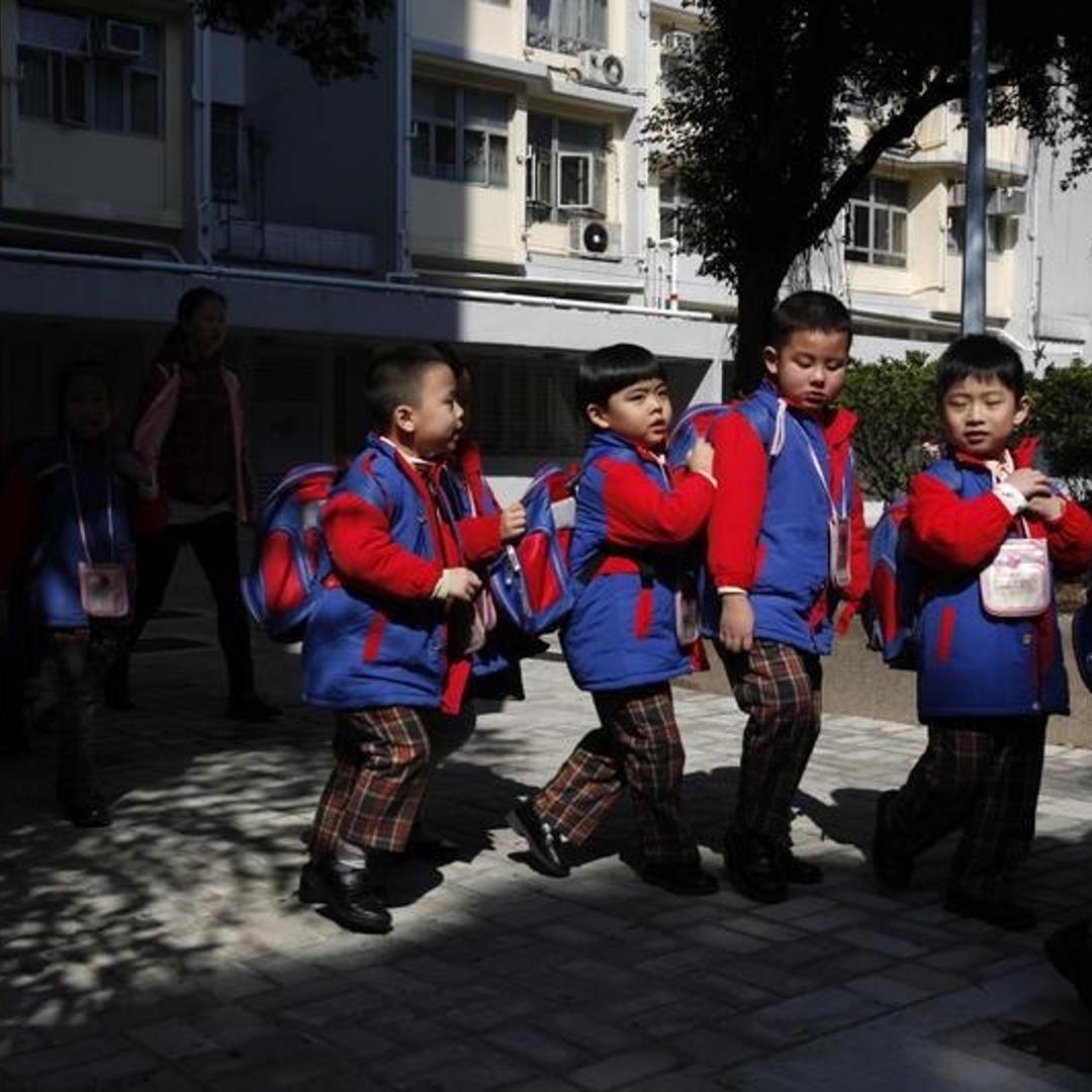 Students, who live in Shenzhen, leave their school at a public housing estate in Hong Kong, before crossing the border back to mainland China