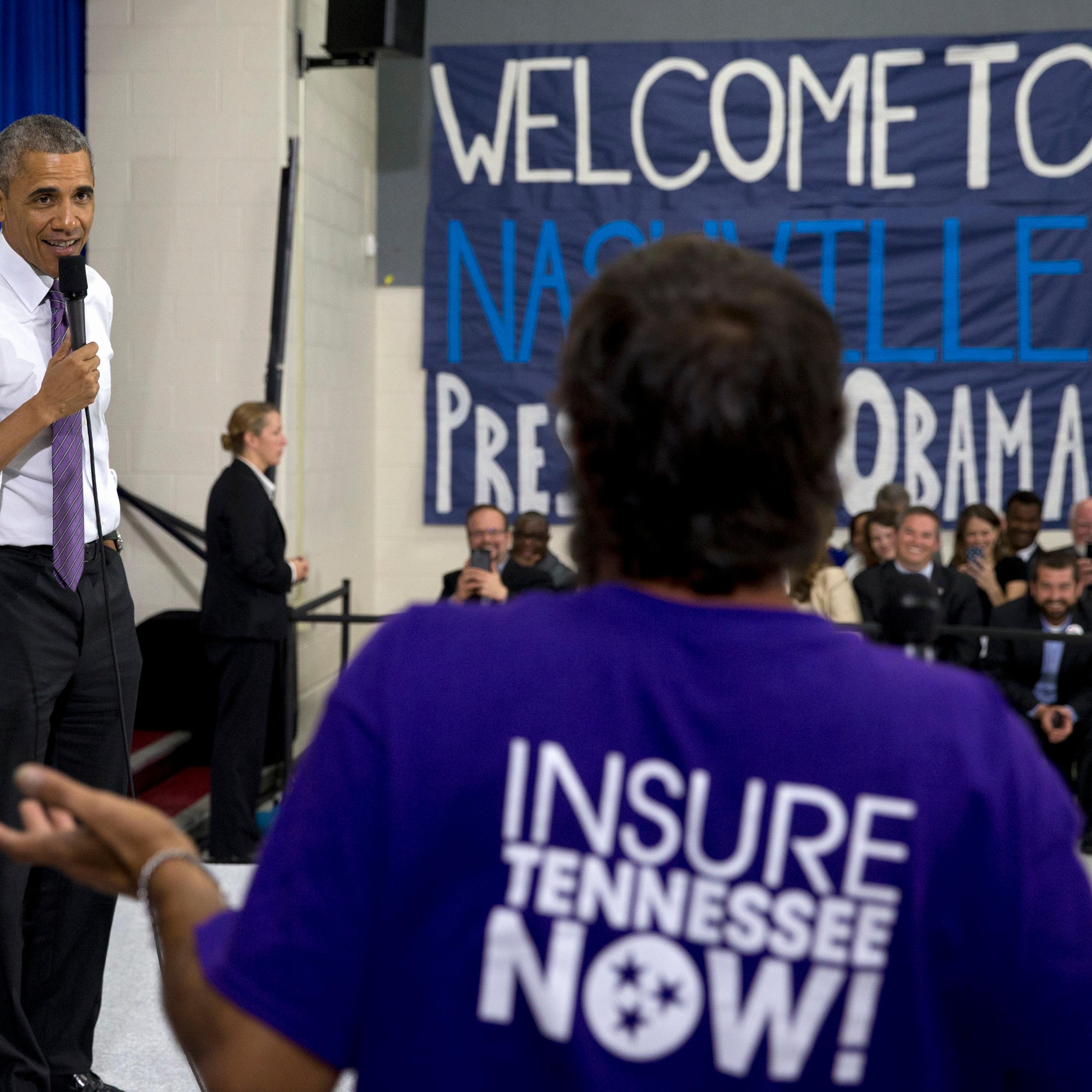 President Barack Obama talks to a man in the audience as he takes questions at Taylor Stratton Elementary School in Nashville on July 1, 2015, about the Affordable Care Act.