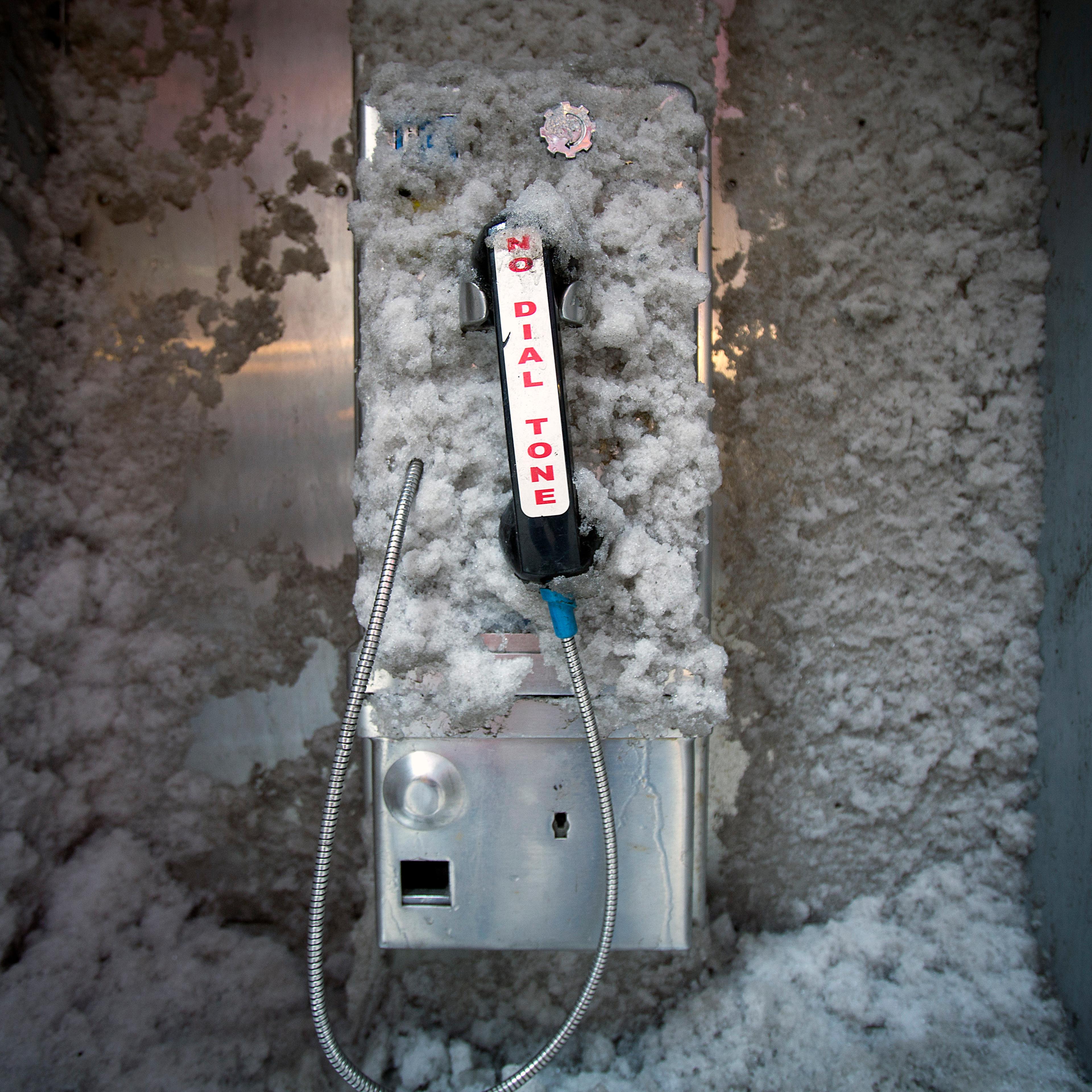 A disused pay phone is covered in snow in Times Square in New York
