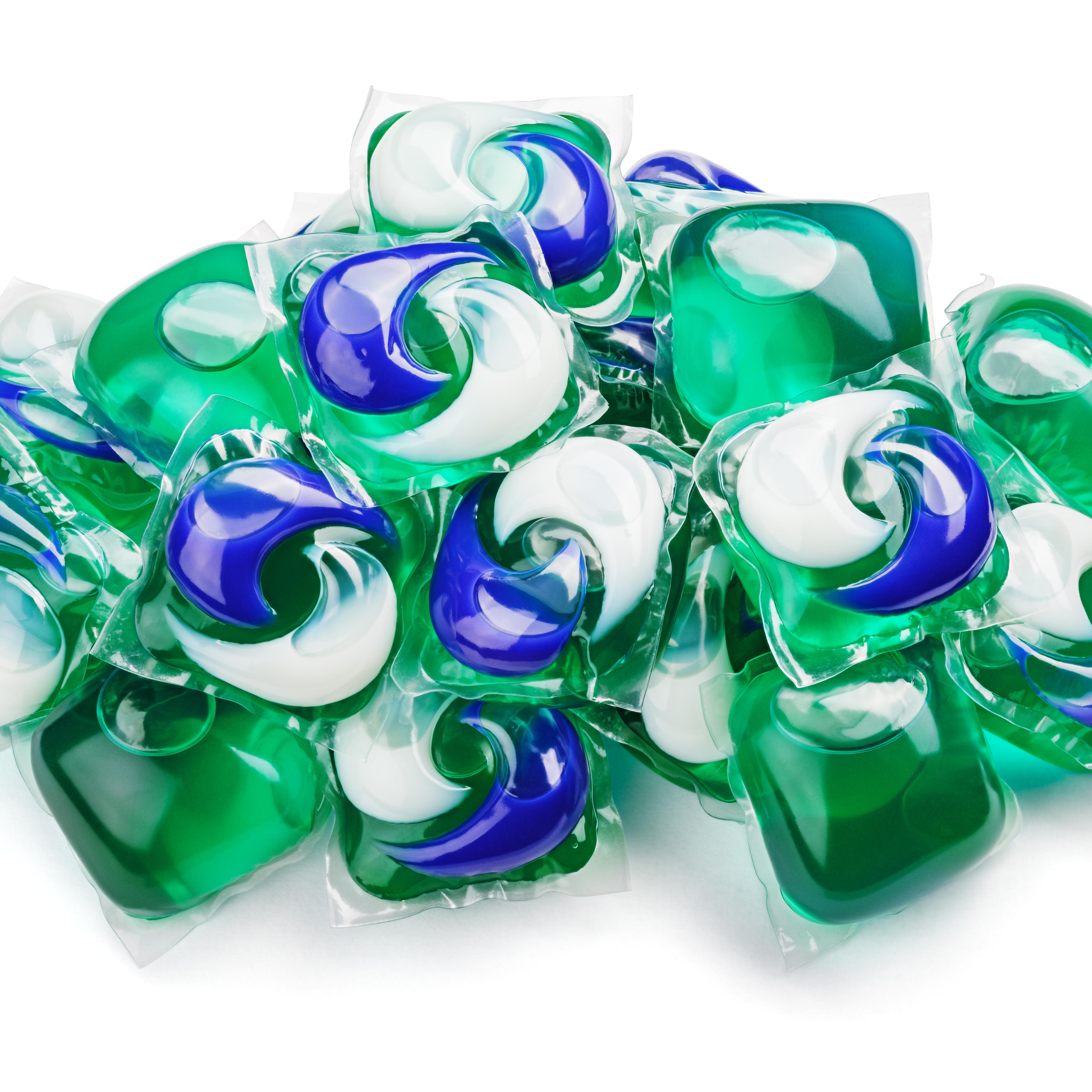 gel capsule pods with laundry detergent on white
