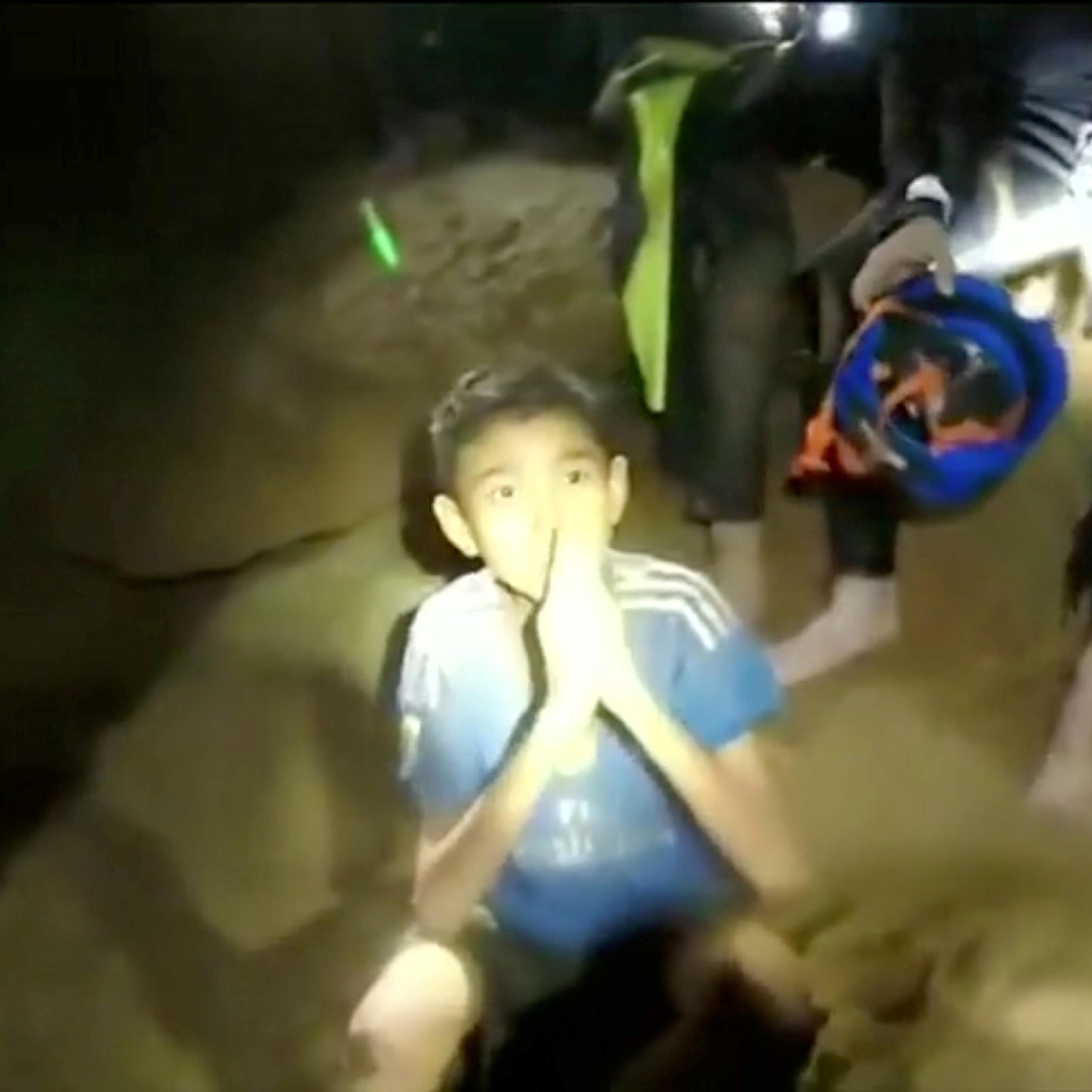 Boys from the under-16 soccer team trapped inside Tham Luang cave greet members of the Thai rescue team in Chiang Rai, Thailand
