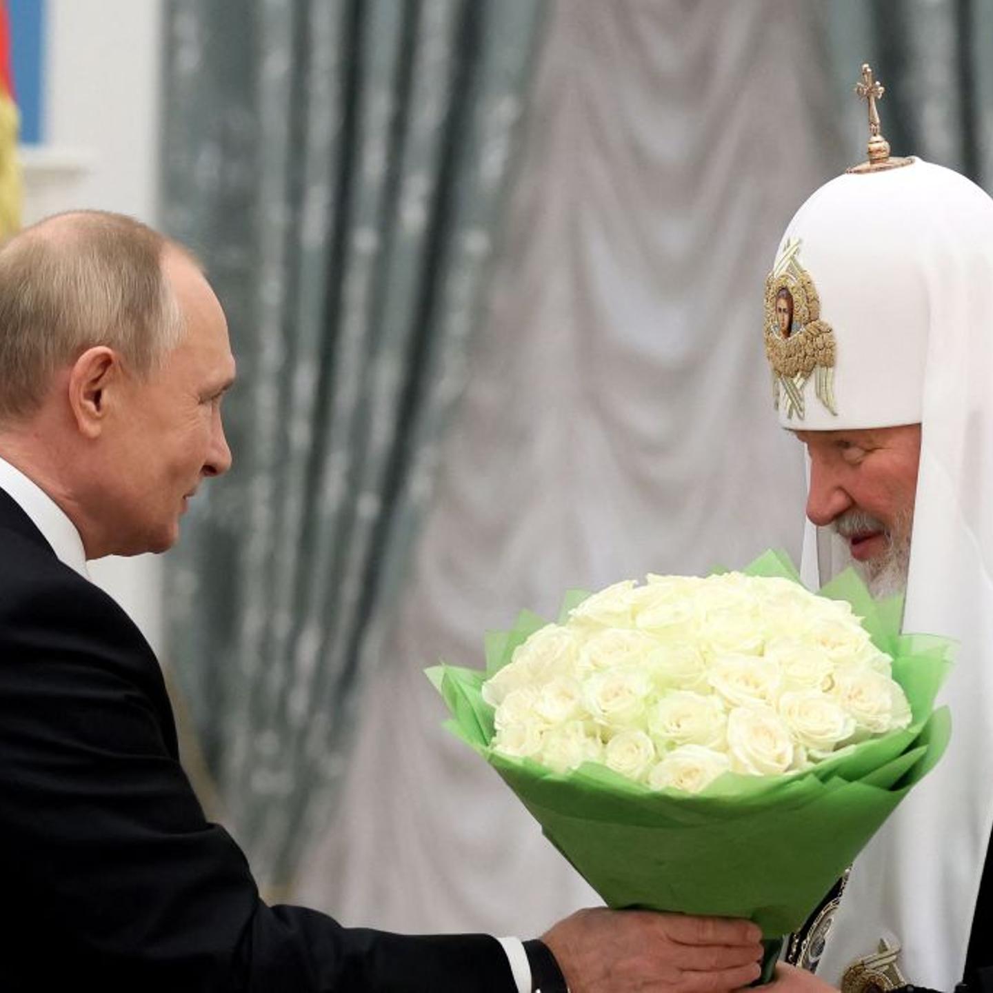 Russia's President Vladimir Putin (L) congratulates Patriarch Kirill of Moscow and All Russia during a presentation ceremony for presenting Andrew the First-Called order in Moscow on Nov. 20, 2021.