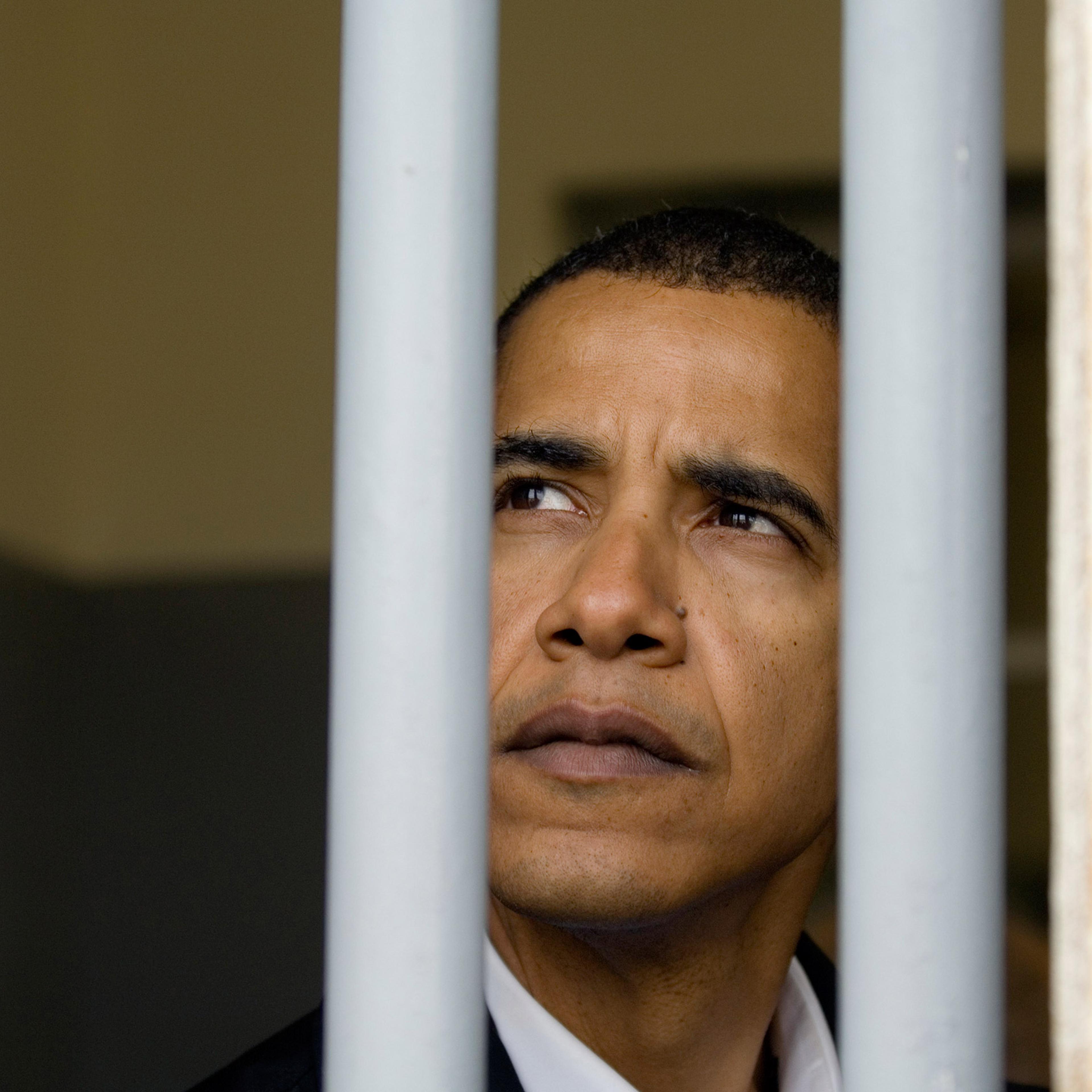 Barack Obama pictured when he was a U.S. Senator (D-Ill.) sitting in Nelson Mandela's prison cell on Robben Island off the coast of Cape Town, South Africa, on Aug. 20, 2006.