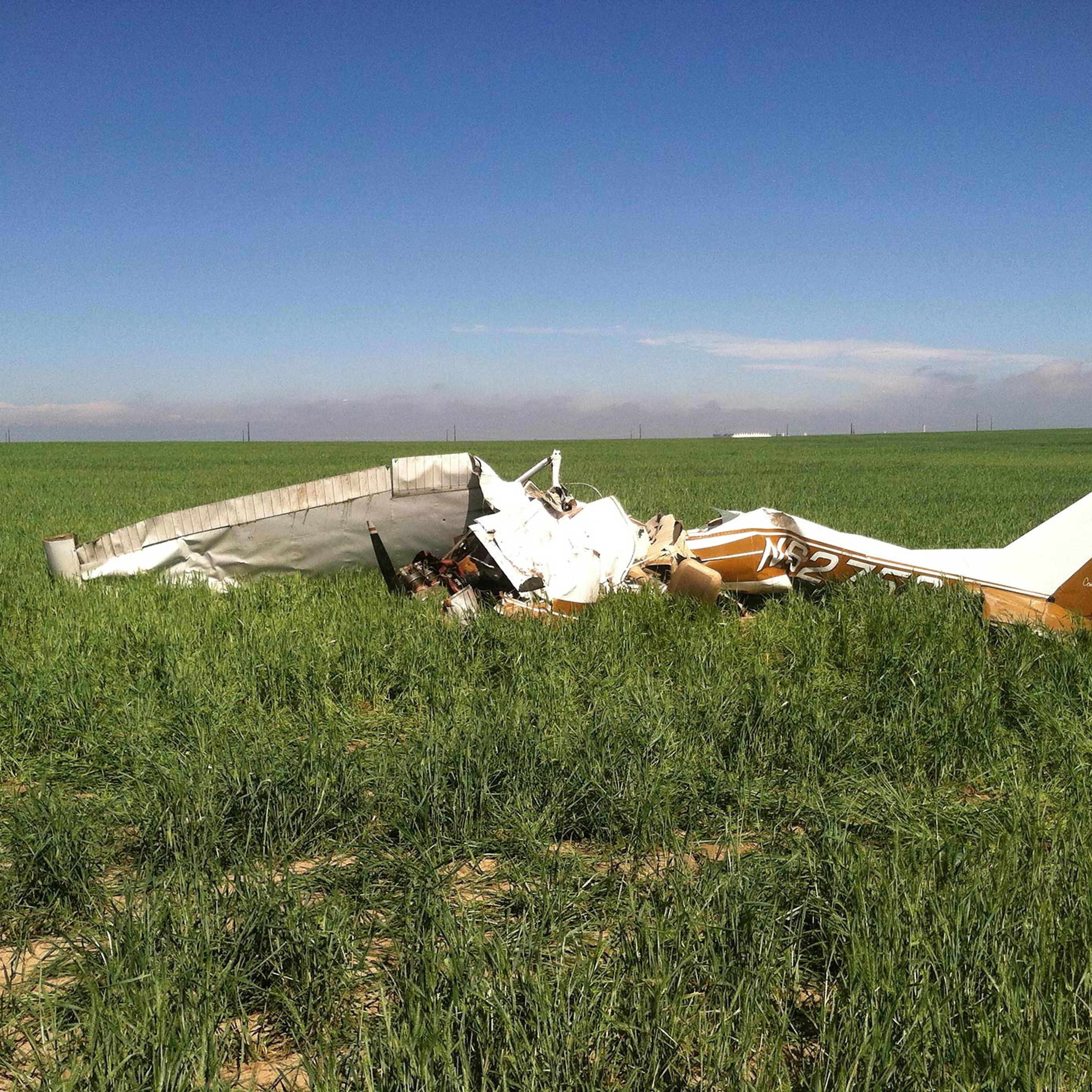 File photo of the wreckage of a crashed Cessna 150 airplane lying in a field near Watkins, Colorado