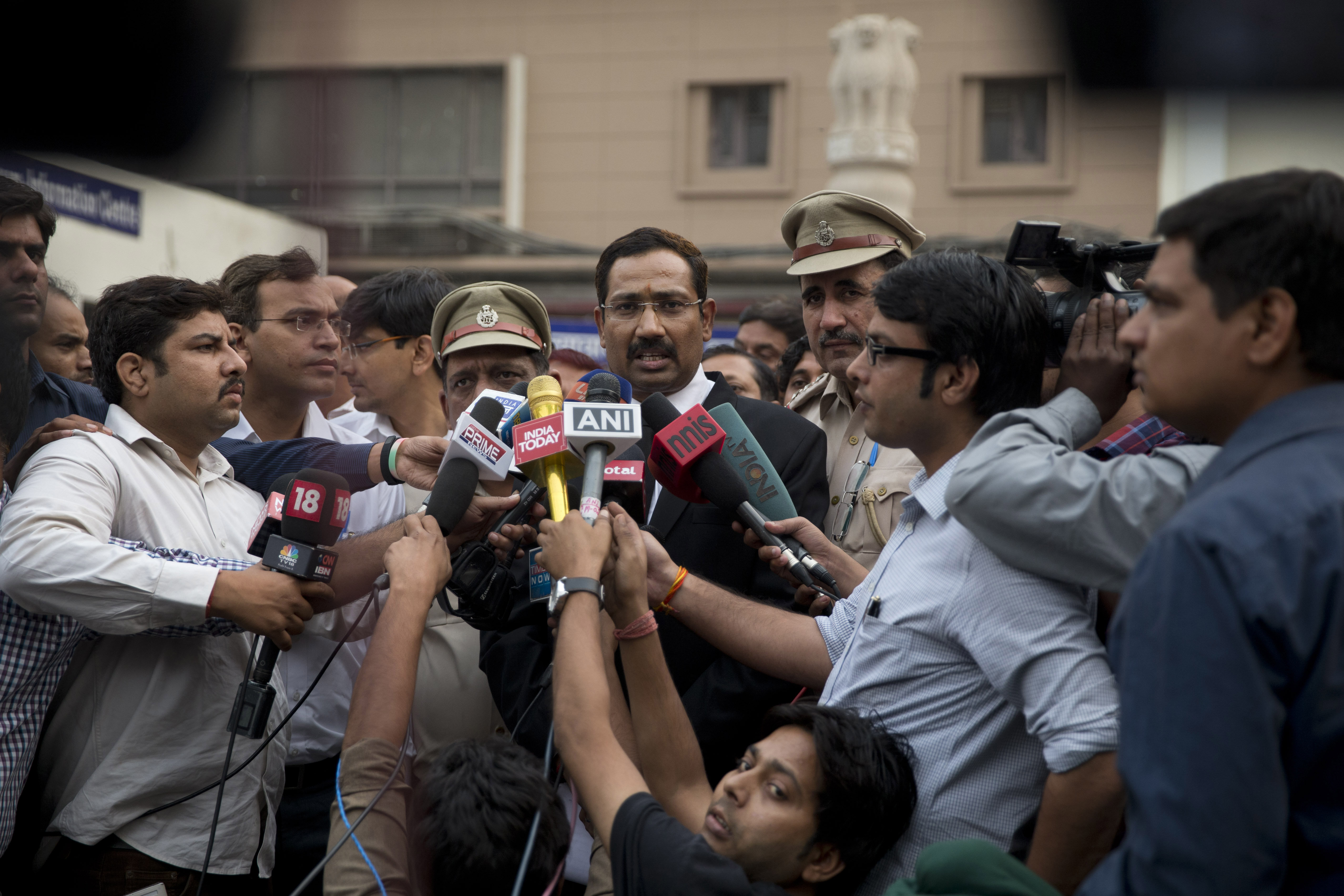 A lawyer, center, speaks to reporters at the Tis Hazari Courts premises, after a court sentence for Uber driver Shiv Kumar Yadav in New Delhi on Tuesday, Nov. 3, 2015. An Indian court sentenced Uber driver Yadav to life in prison Tuesday for raping a pas