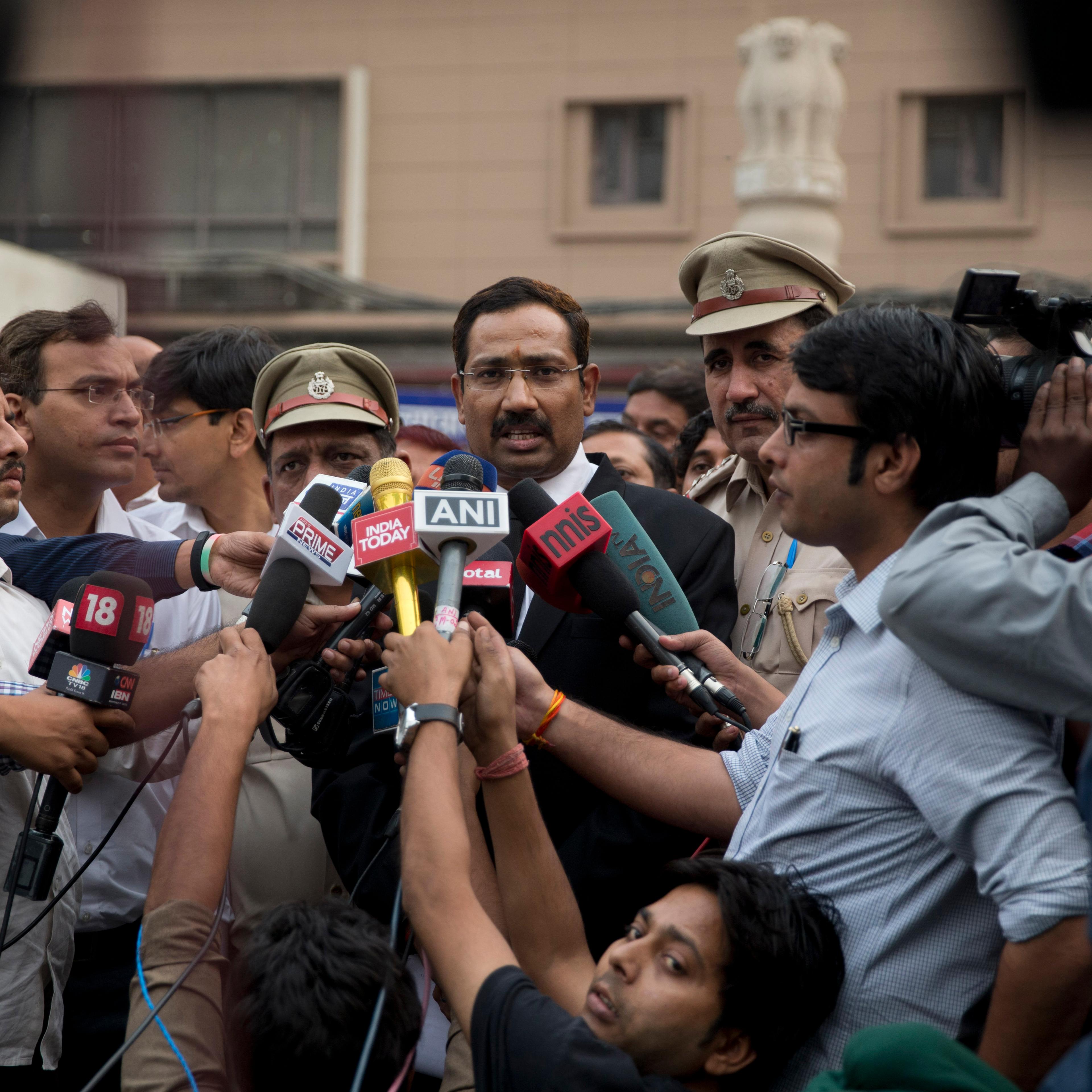A lawyer, center, speaks to reporters at the Tis Hazari Courts premises, after a court sentence for Uber driver Shiv Kumar Yadav in New Delhi on Tuesday, Nov. 3, 2015. An Indian court sentenced Uber driver Yadav to life in prison Tuesday for raping a pas