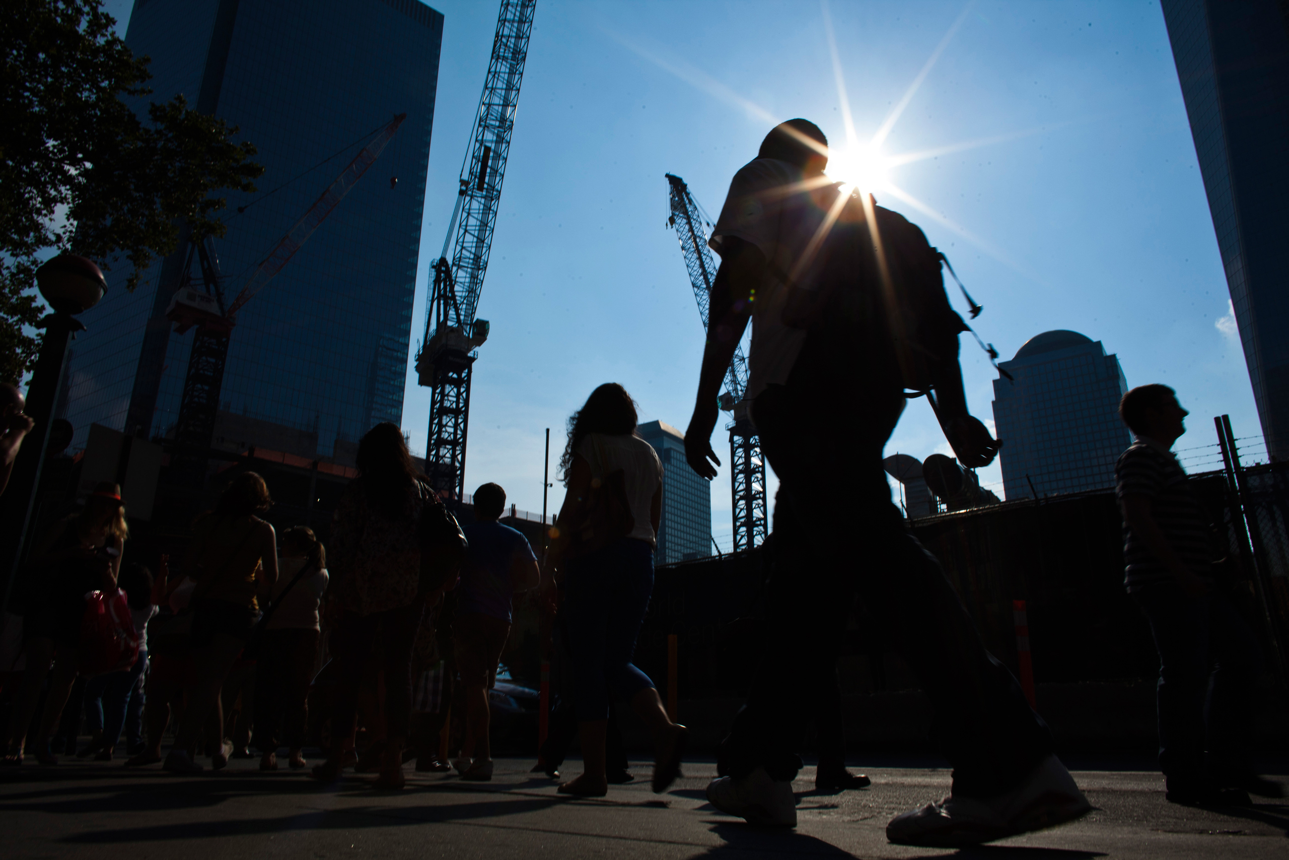 People walk near the World Trade Center during a heat wave in Manhattan, New York, July 19, 2013. Temperatures in New York City, the biggest metropolitan area in the United States, are expected to reach 99 degrees Fahrenheit (37 C) Friday and 94 F on Sat