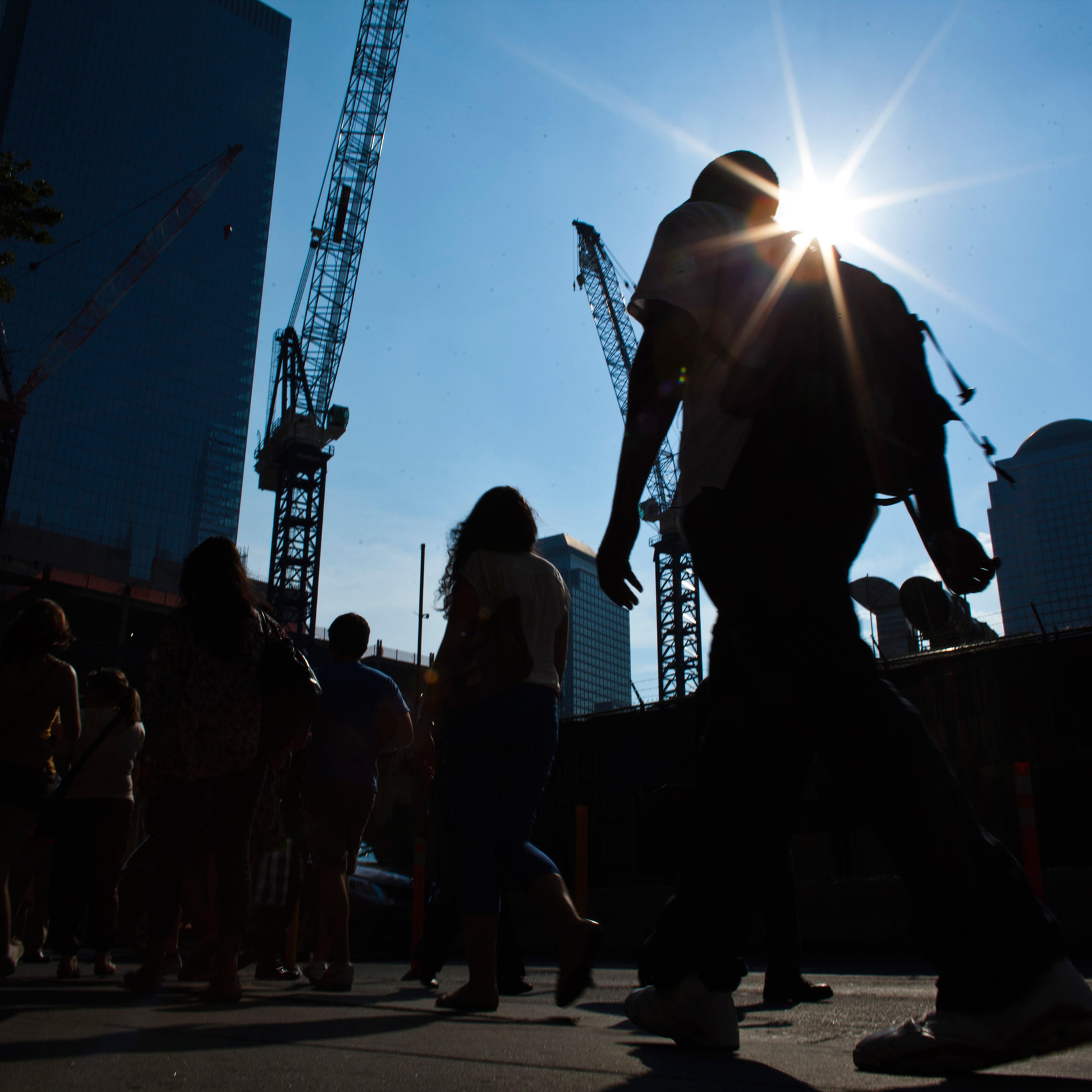 People walk near the World Trade Center during a heat wave in Manhattan, New York, July 19, 2013. Temperatures in New York City, the biggest metropolitan area in the United States, are expected to reach 99 degrees Fahrenheit (37 C) Friday and 94 F on Sat