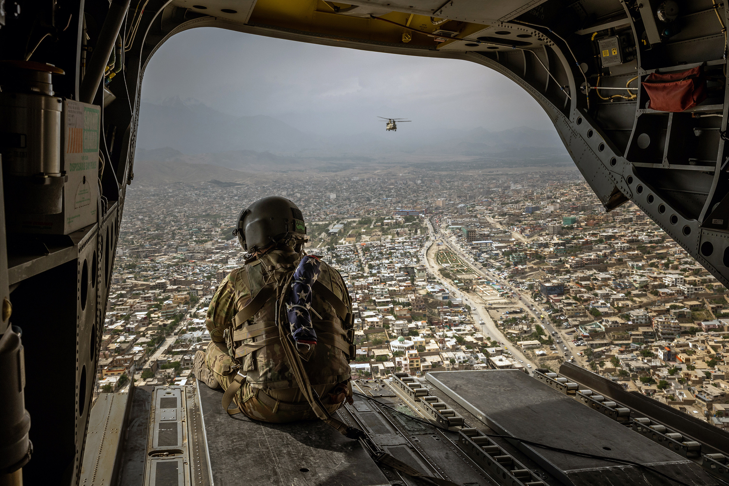 An American soldier on a CH-47 Chinook helicopter flying over Kabul, Afghanistan's capital, on May 2.