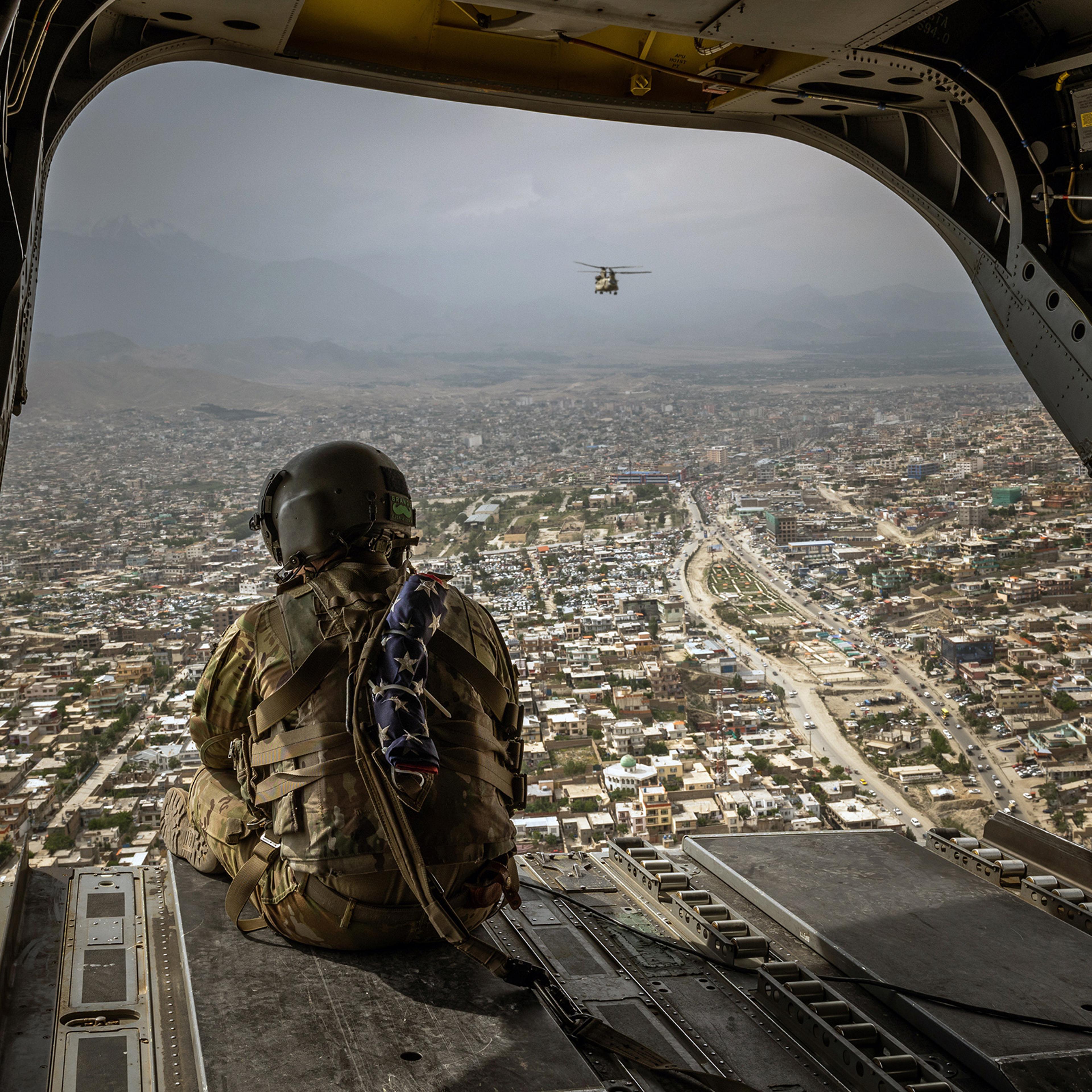 An American soldier on a CH-47 Chinook helicopter flying over Kabul, Afghanistan's capital, on May 2.