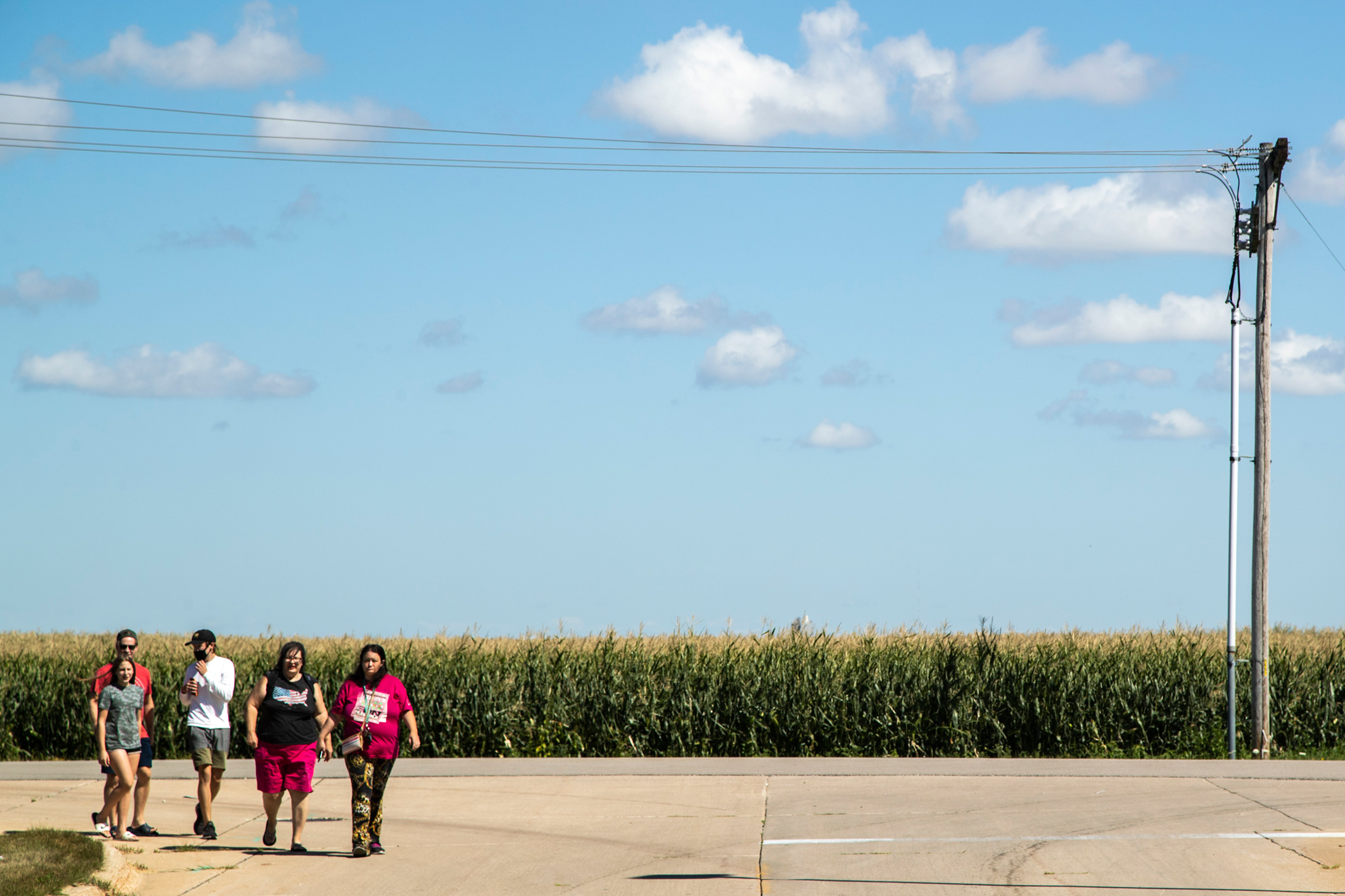 People arrive to watch Air Force One land, on Aug. 18, 2020, as President Donald Trump visits with Iowa leaders after a derecho on Aug. 10, in Cedar Rapids, Iowa.