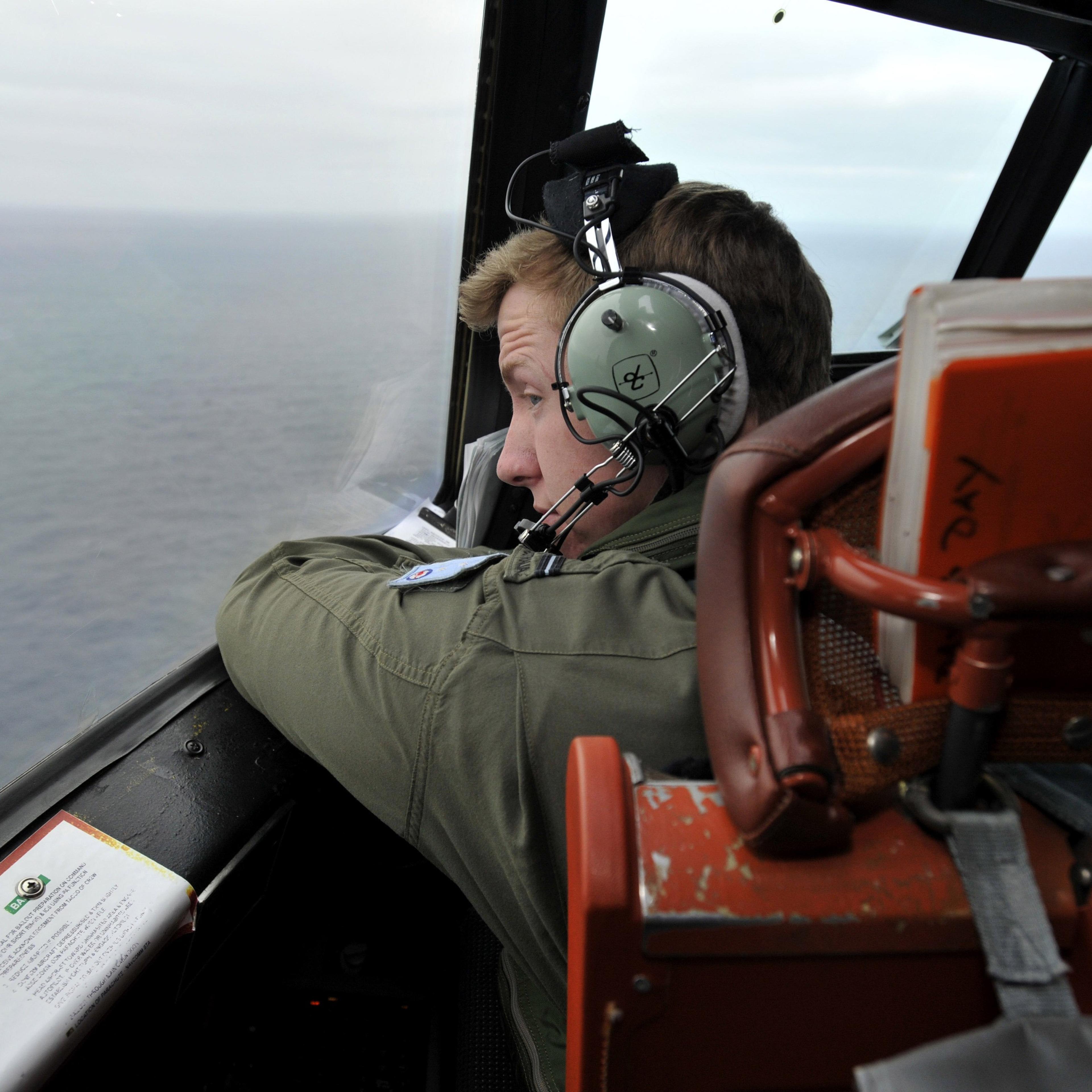 Flying Officer Benjamin Hepworth searches from a Royal Australian Airforce AP-3C Orion from Pearce Airforce Base during a search mission for possible MH370 debris on March 21, 2014 in Perth, Australia.