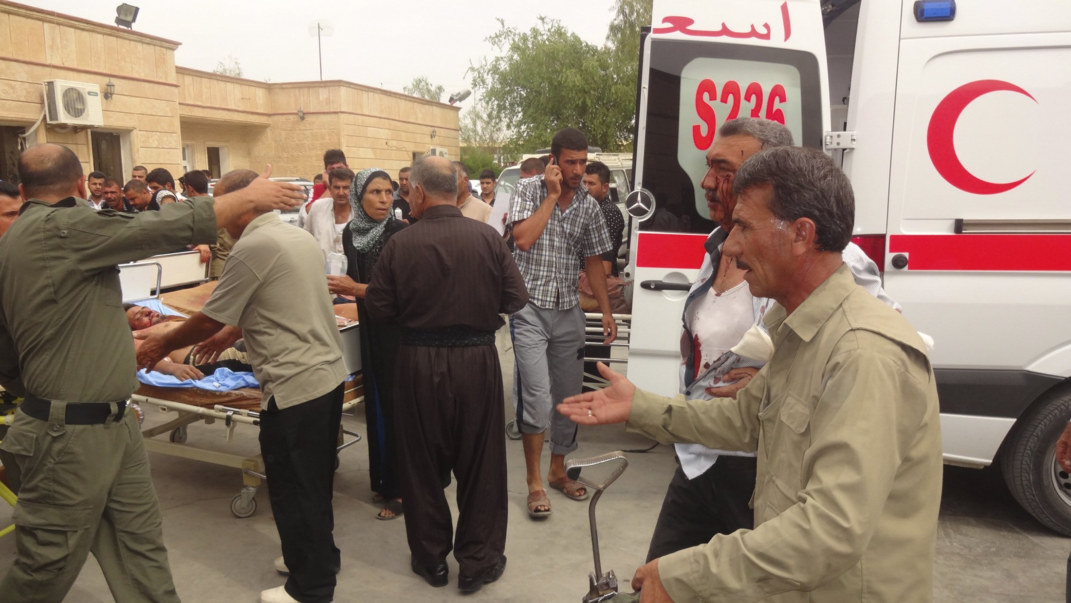 Men wounded by a car bomb in Qara Qubah are transported to a hospital in Kifri, Iraq on Oct. 12, 2014.